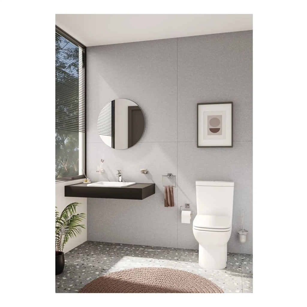 Contemporary bathroom featuring a sleek floating black vanity with an integrated sink, modern round mirror, minimalistic artwork, and a white toilet, all set against a textured grey wall with natural light from large window.