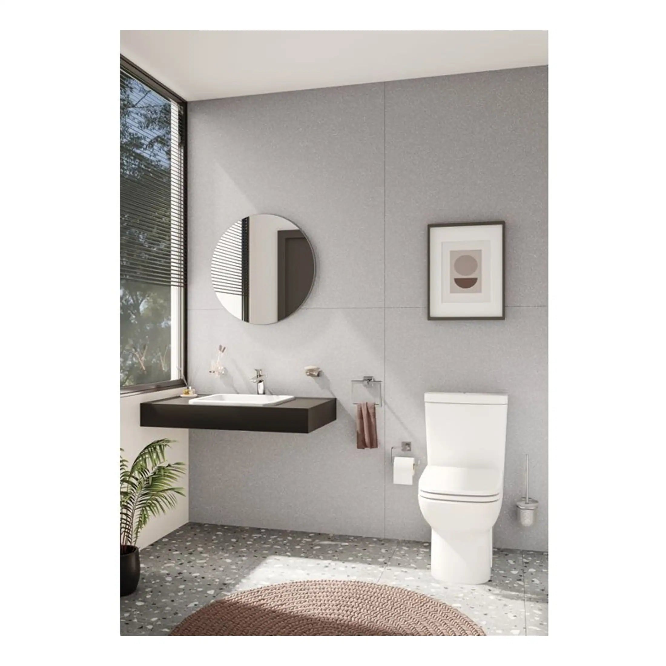 Contemporary bathroom featuring a sleek floating black vanity with an integrated sink, modern round mirror, minimalistic artwork, and a white toilet, all set against a textured grey wall with natural light from large window.