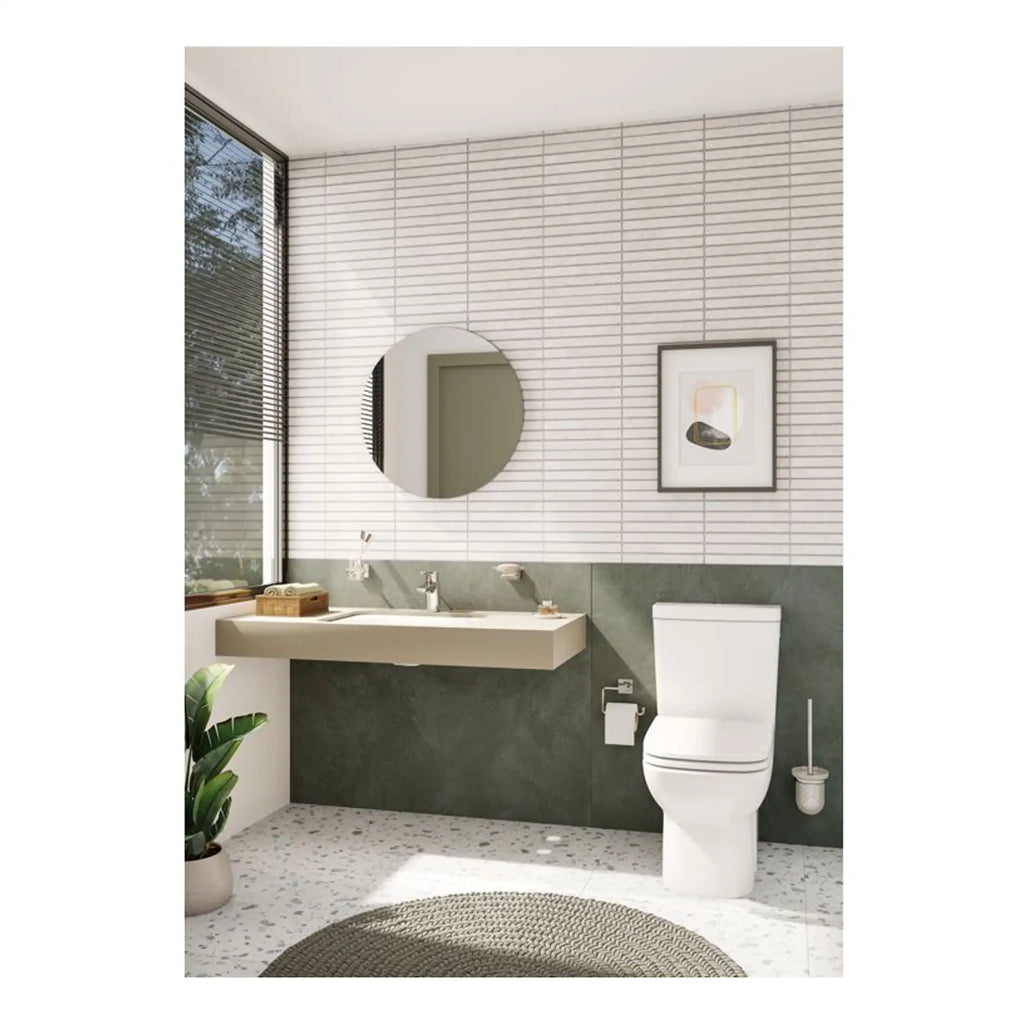 Modern bathroom with sleek design, ceramic toilet, floating sink, round mirror, large window, framed artwork, and minimalist decor, perfect for contemporary bathroom renovations.