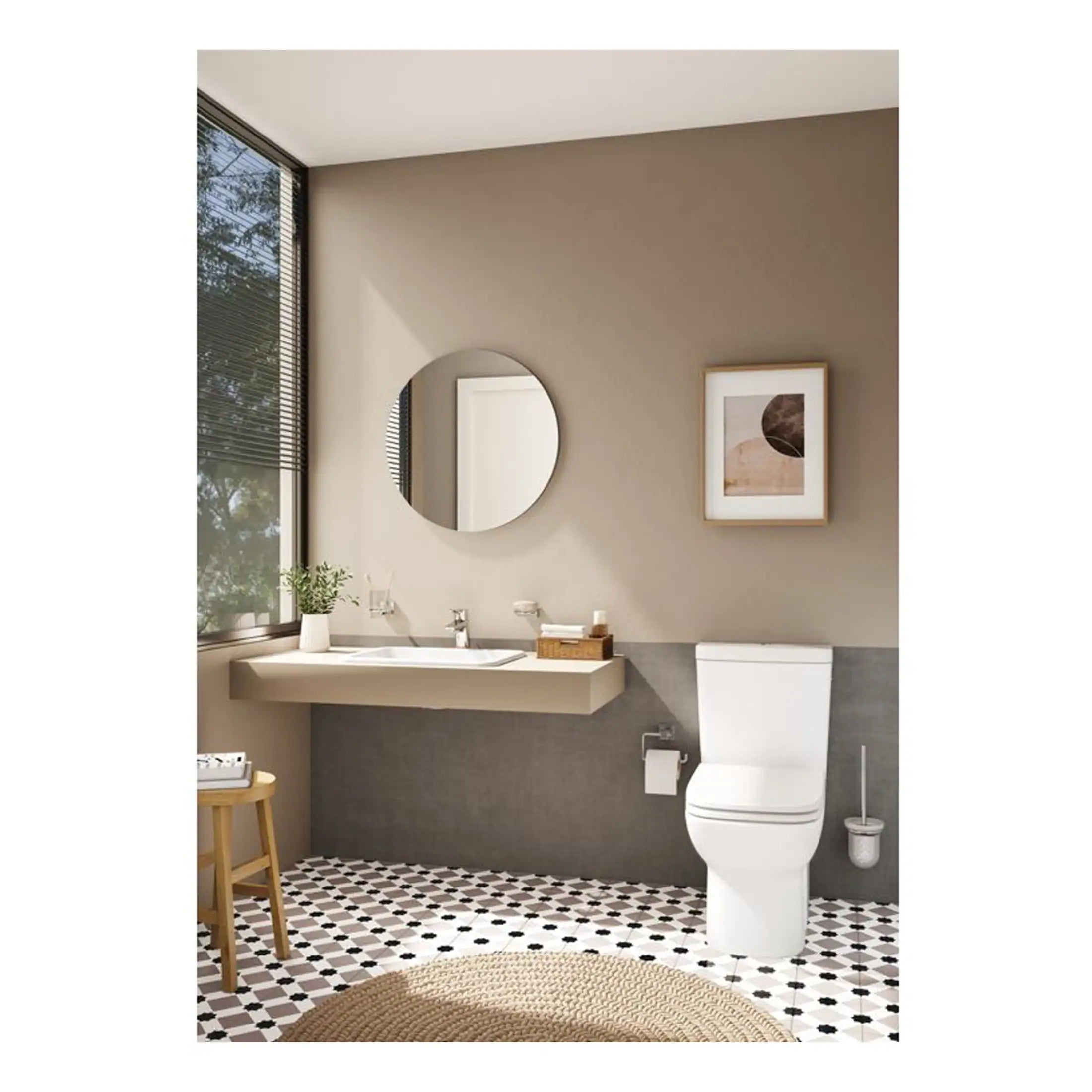 Modern minimalist bathroom with beige walls, geometric black and white floor tiles, white toilet, floating sink, round mirror, and decorative framed artwork. Perfect for contemporary bathroom designs.