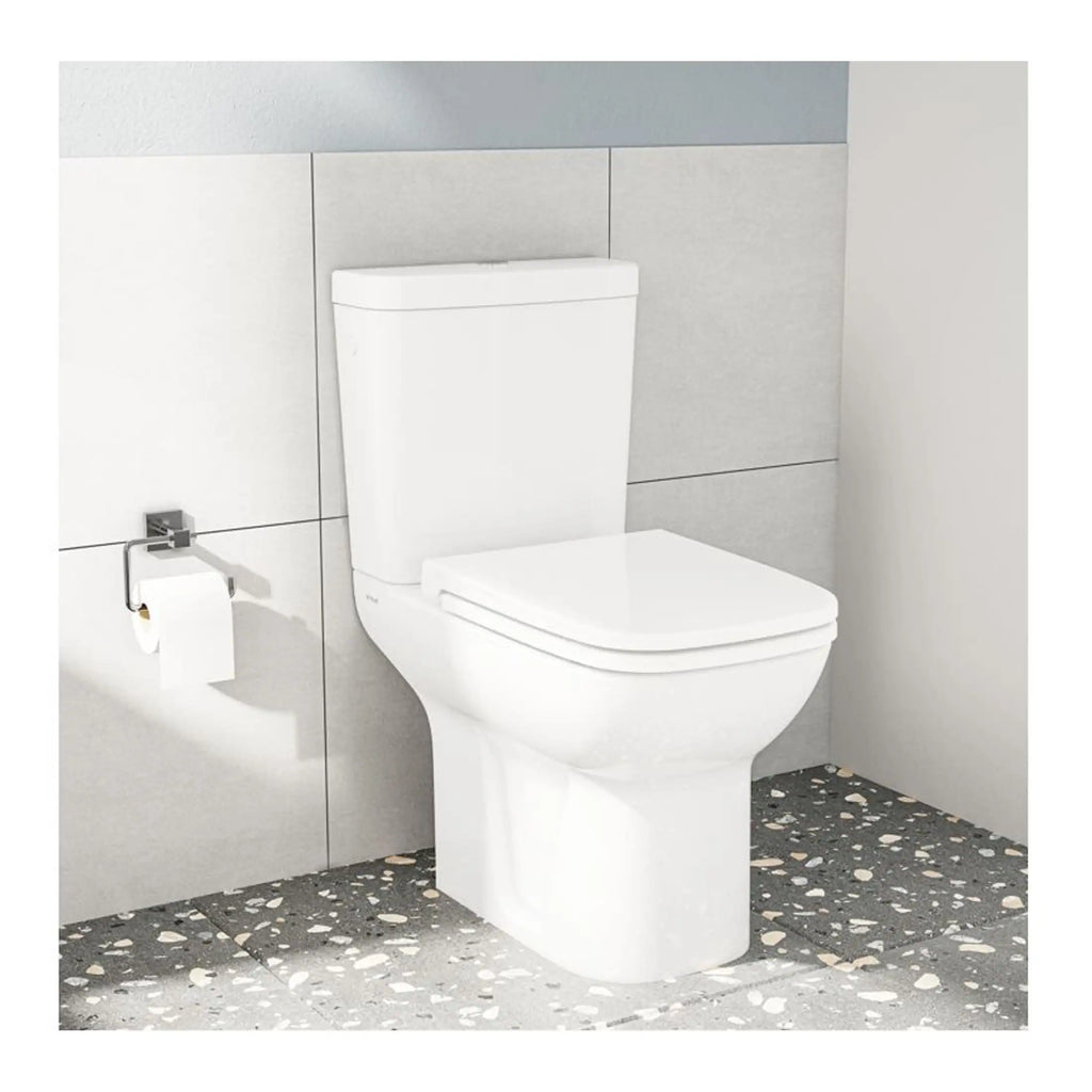 Toilet bowl with modern cistern in minimalist bathroom setting, clean and sleek design, suitable for contemporary bathrooms, complemented by mosaic floor tiles and neutral wall tiles, emphasizing hygiene and comfort.