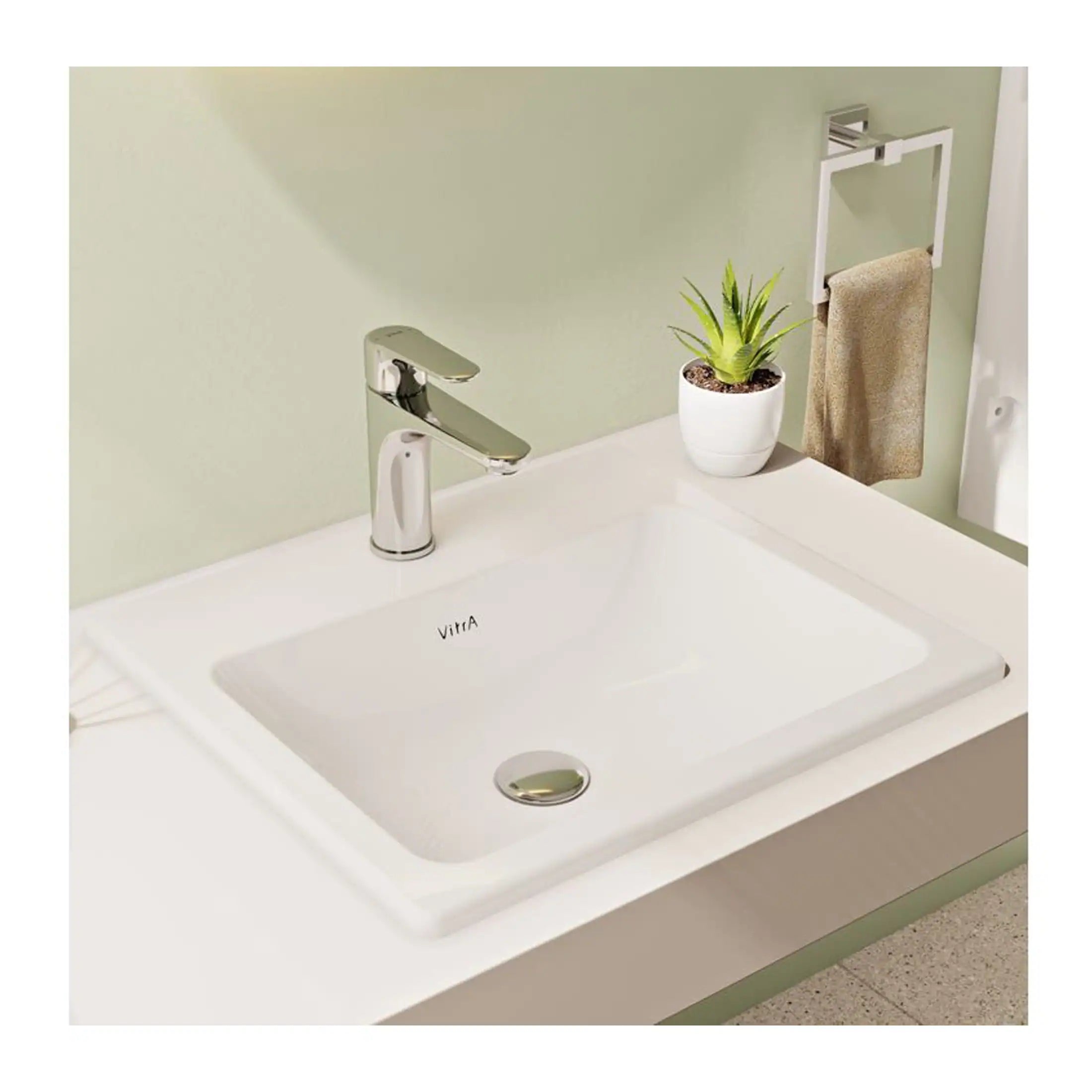Modern white bathroom sink with chrome faucet, potted plant, and beige towel on wall-mounted holder, creating a clean and minimalist bathroom aesthetic.