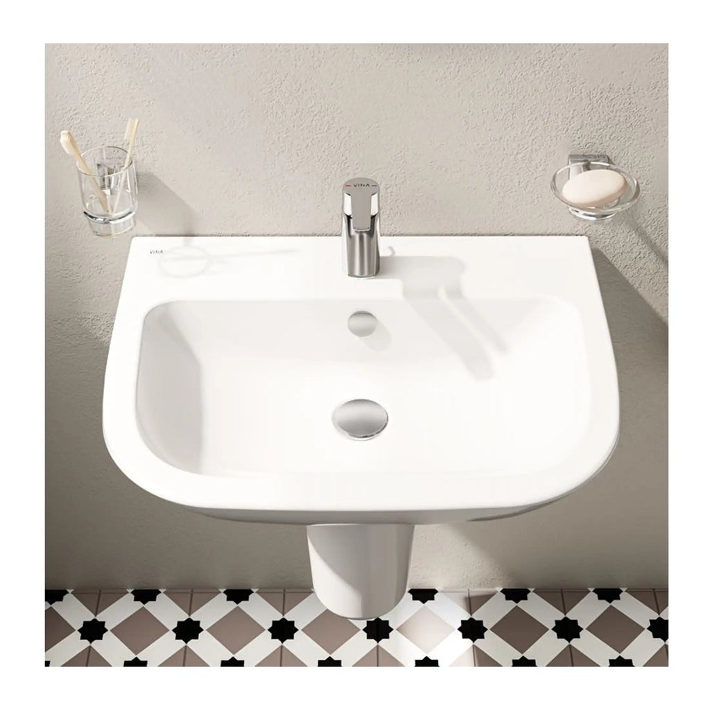 Sleek white bathroom sink with modern chrome tap, wall-mounted design, and minimalist accessories including toothbrush holder and soap dish on a neutral wall, perfect for contemporary bathroom décor.