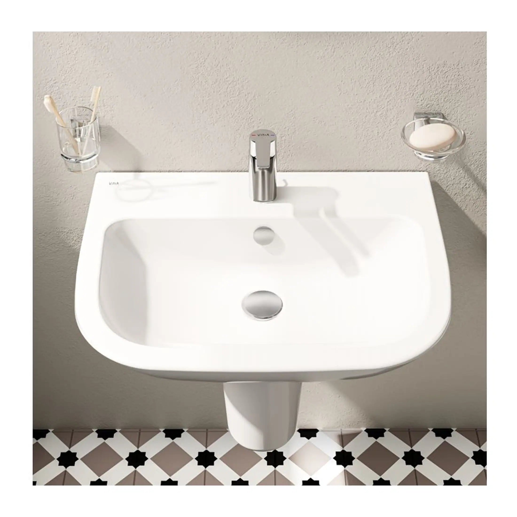 Sleek white bathroom sink with modern chrome tap, wall-mounted design, and minimalist accessories including toothbrush holder and soap dish on a neutral wall, perfect for contemporary bathroom décor.