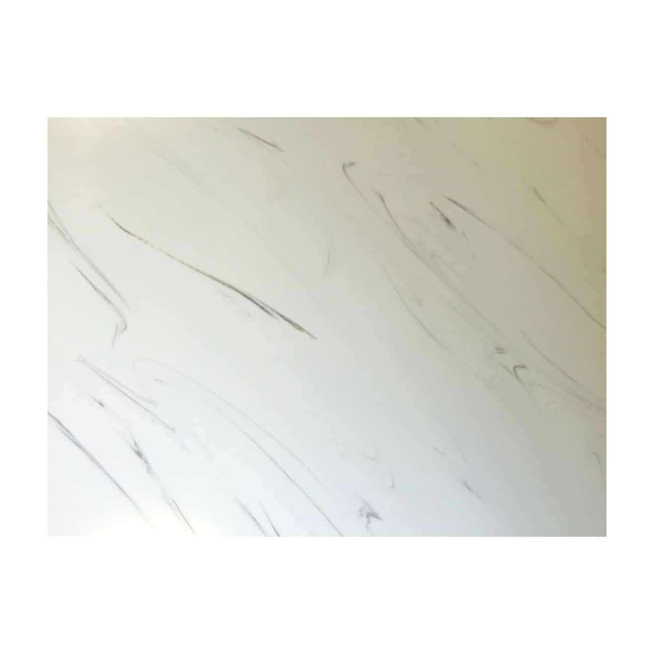 Smooth white marble bathroom wall with grey veining, modern and elegant bathroom decor, high-quality marble surface in contemporary bathroom design, luxurious interior style.