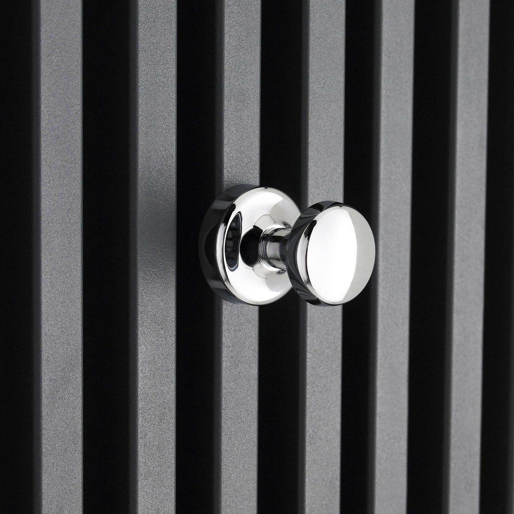 Chrome towel hook on black slatted wall, modern bathroom accessories, sleek and durable bathroom hardware, stylish chrome finish.