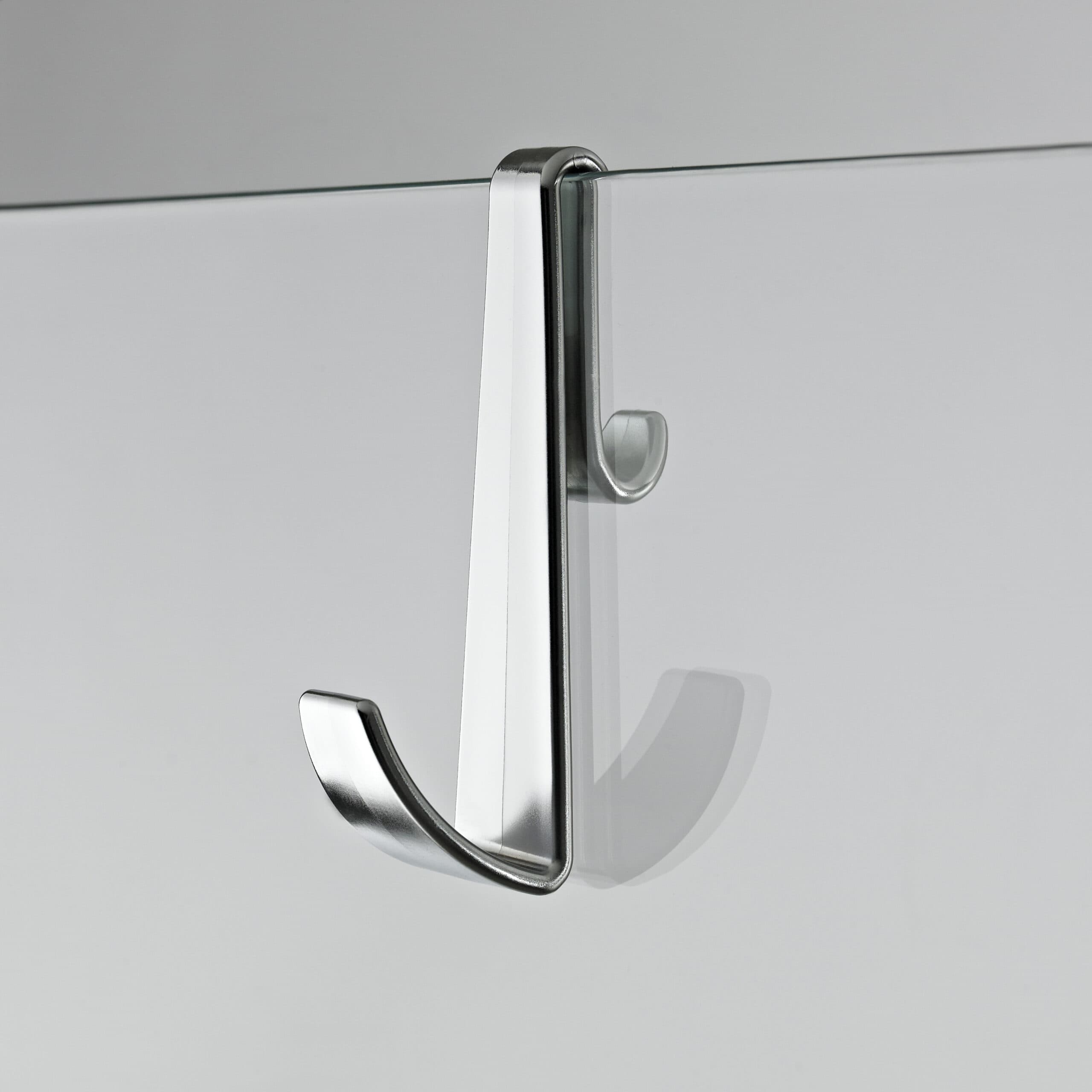 Modern glass shower door with sleek chrome handle for contemporary bathroom design.