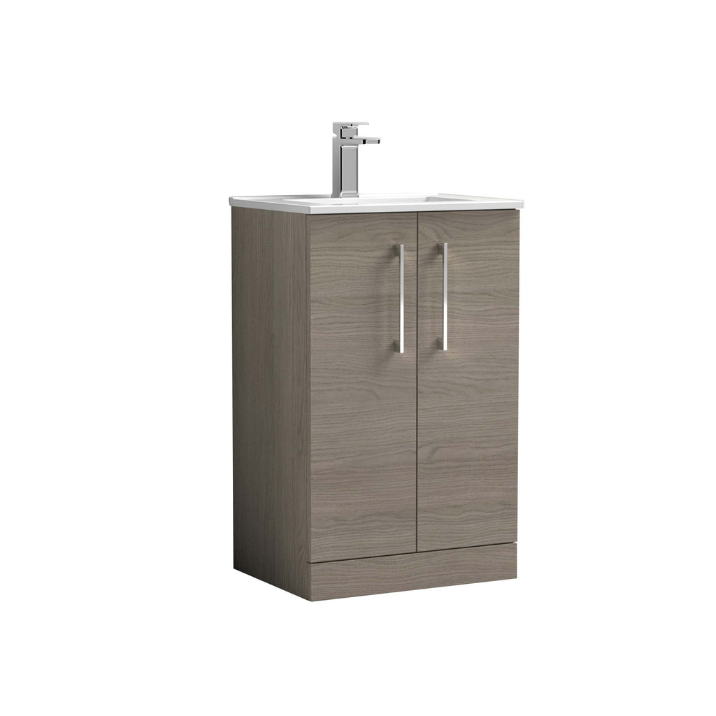 Modern bathroom vanity unit with a white countertop and chrome faucet, featuring a natural wood finish with silver handles for stylish storage solutions.