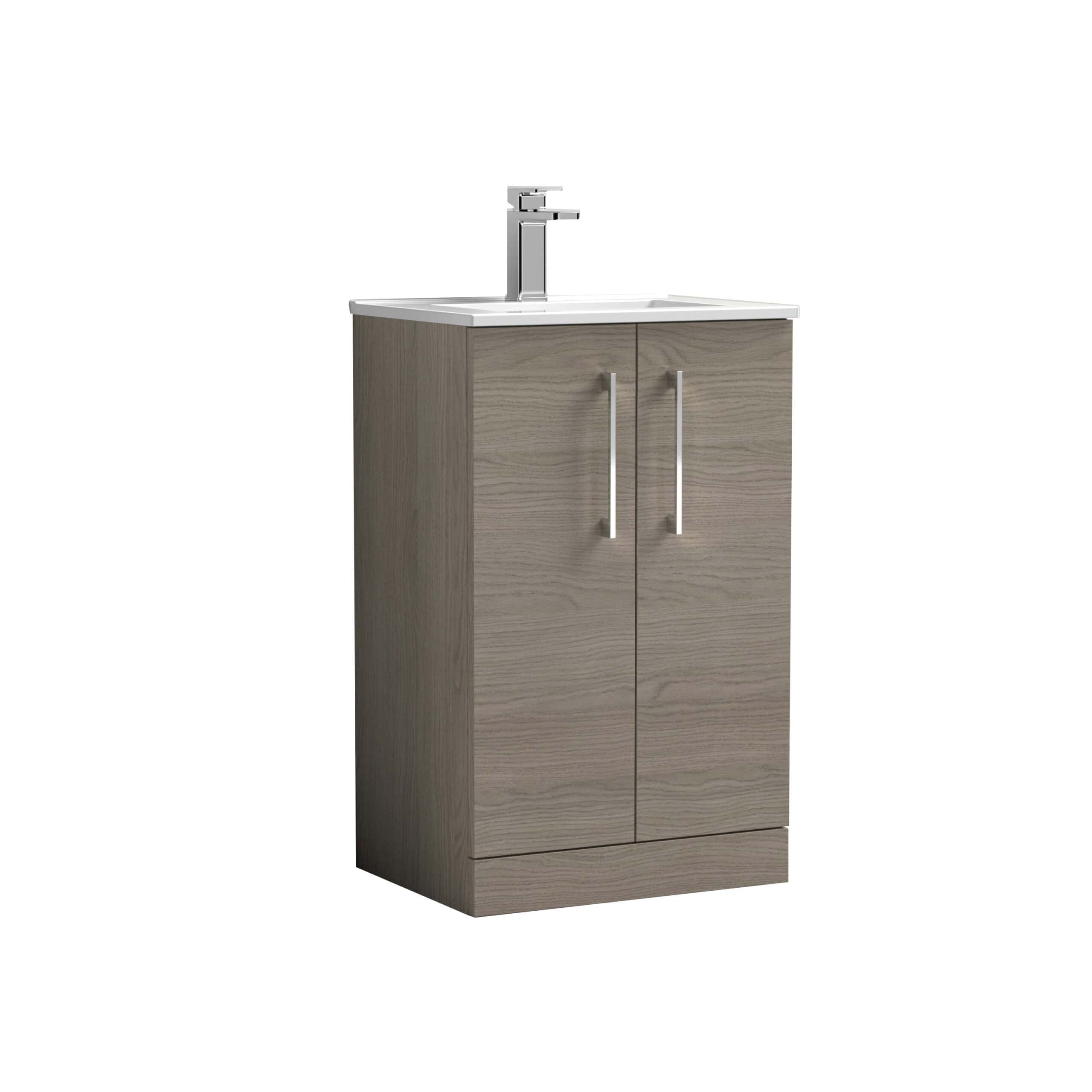 Modern bathroom vanity unit with a white countertop and chrome faucet, featuring a natural wood finish with silver handles for stylish storage solutions.