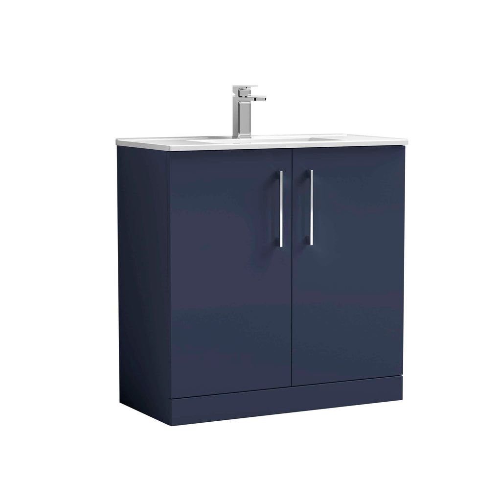 Modern navy blue bathroom vanity unit with dual cabinet doors and white countertop with integrated sink and chrome faucet, ideal for contemporary bathroom designs.