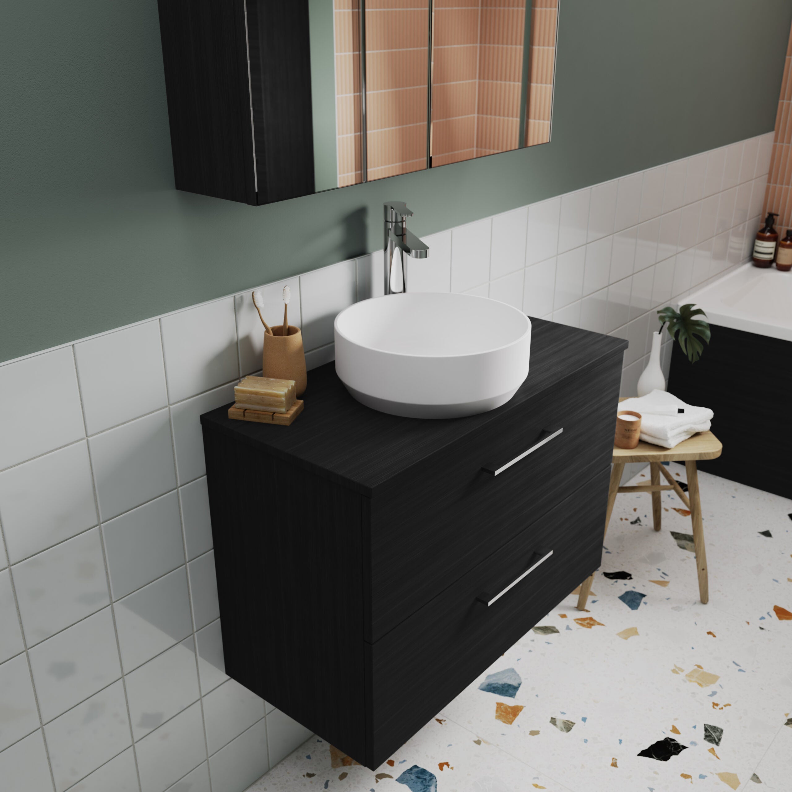 Modern black bathroom vanity with a round white vessel sink and sleek chrome faucet, set against green walls with tiled accents, in a stylish and functional bathroom space.