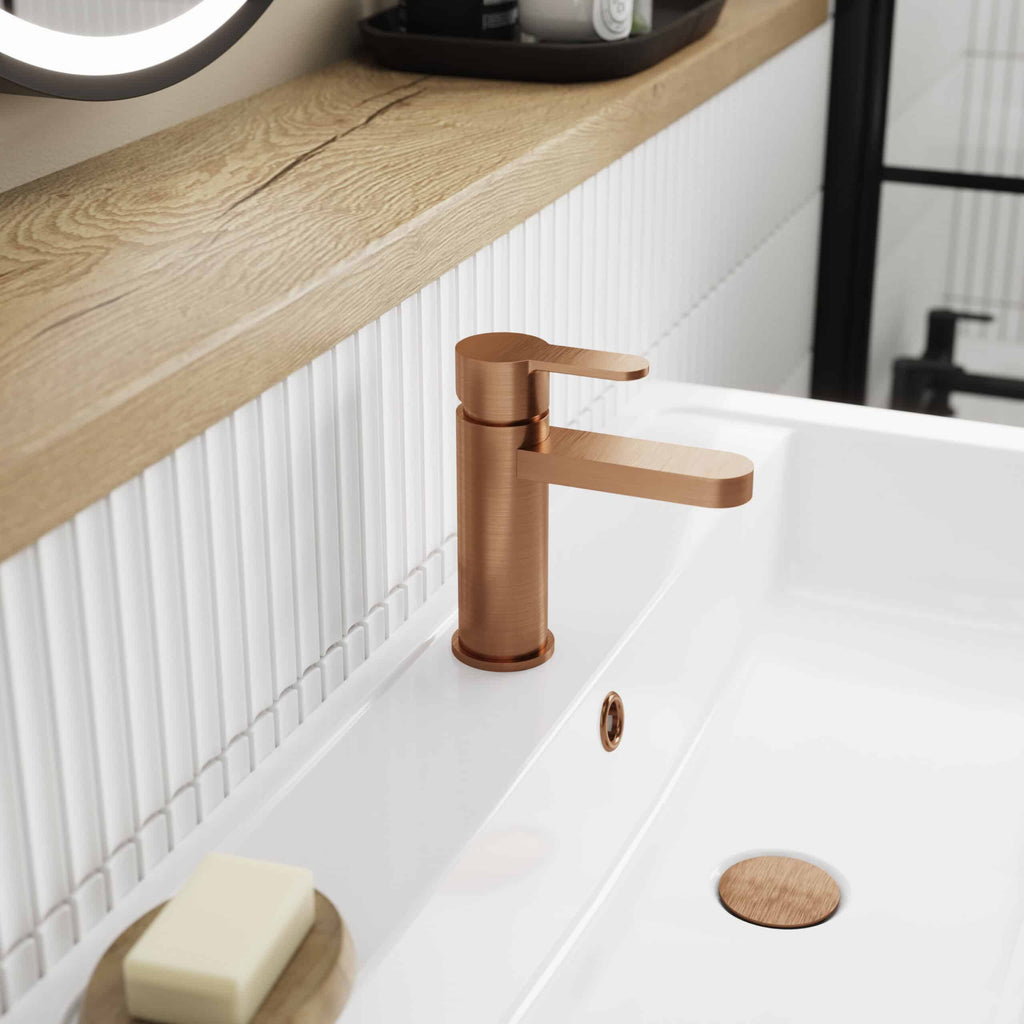Sleek rose gold bathroom sink tap with modern design, set against a minimalist white sink and wood vanity, perfect for contemporary bathroom upgrade.