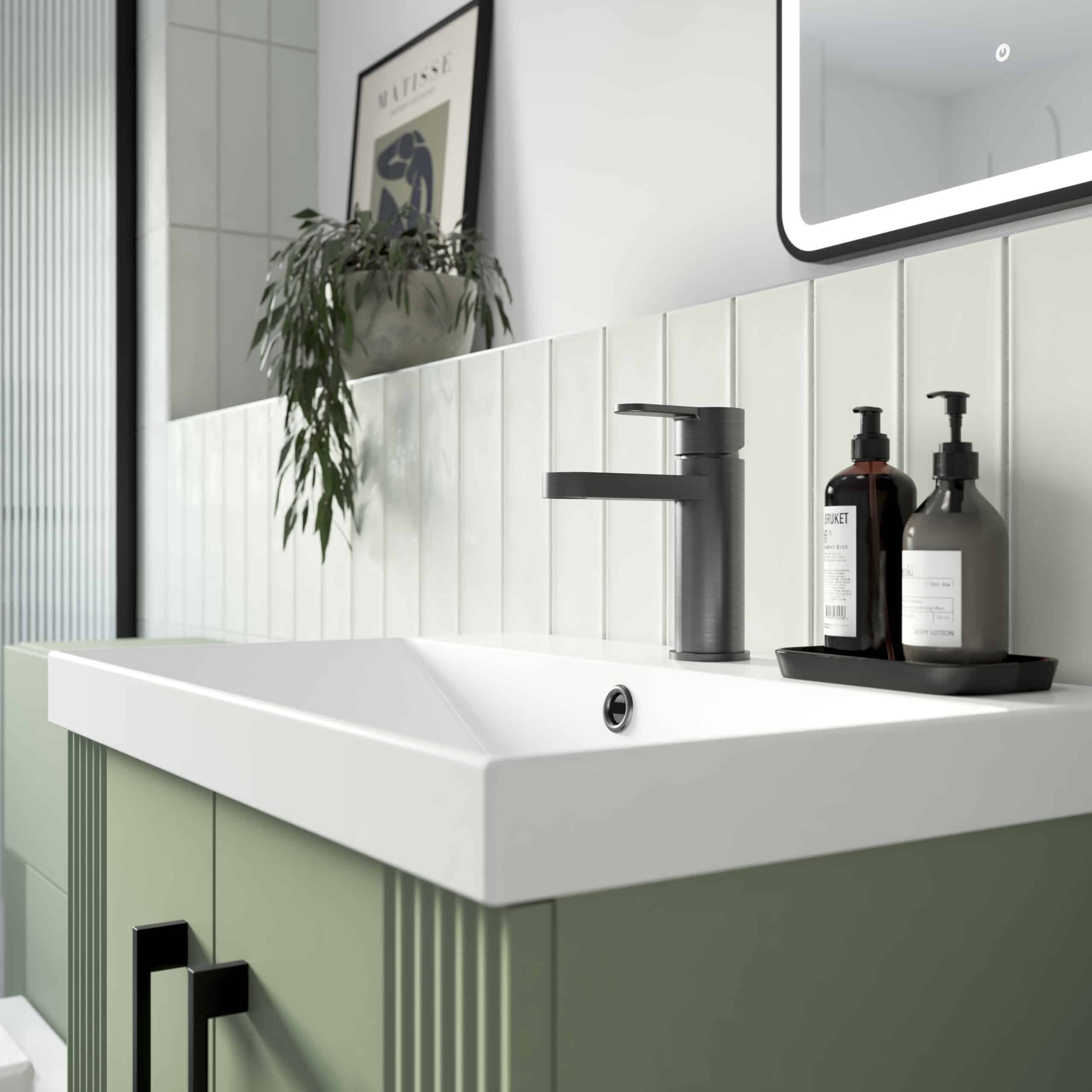 Sleek modern bathroom sink with black matte faucet and stylish accessories, minimalist design, clean white basin, green vanity, and decorative elements, perfect for contemporary bathroom interiors.