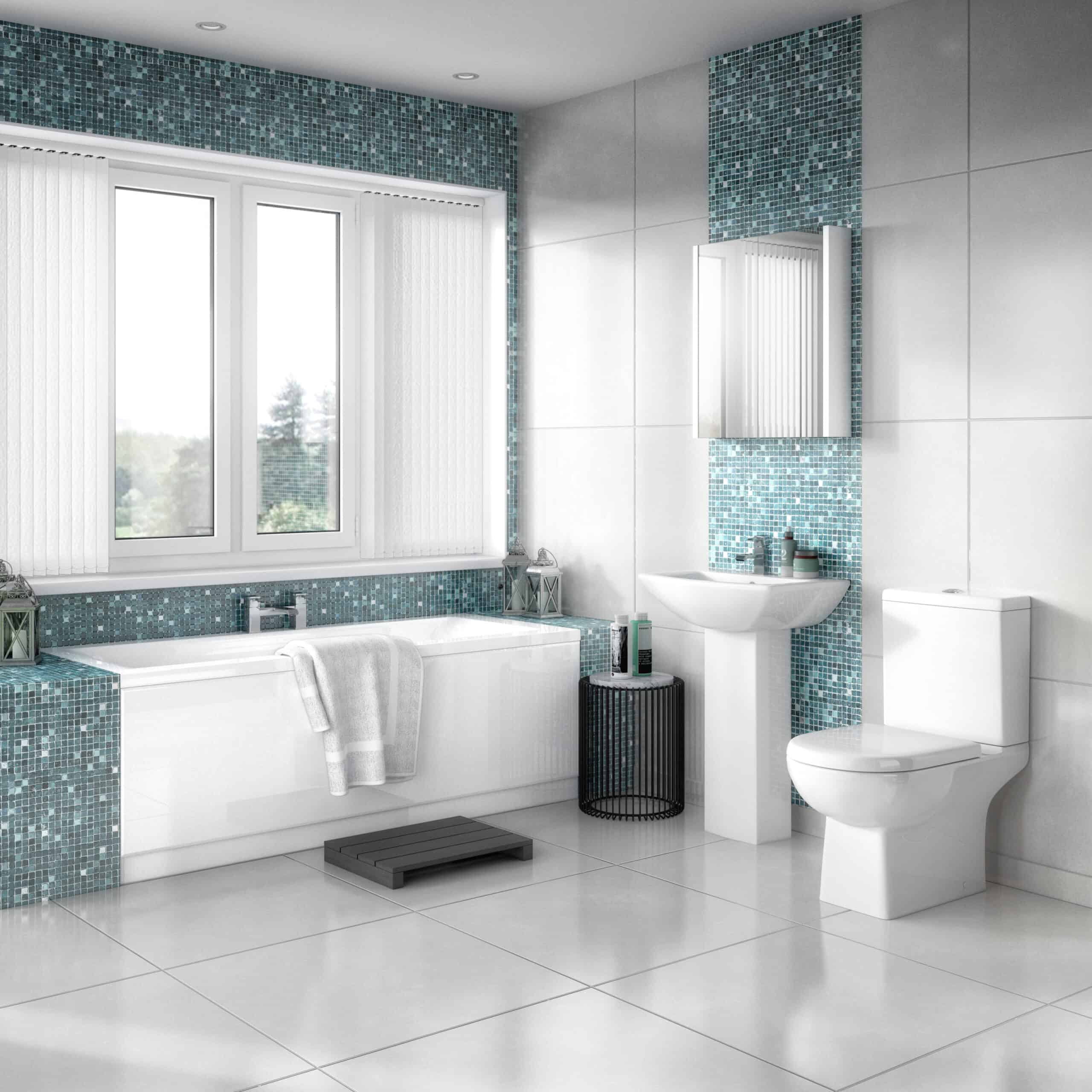 Bright modern bathroom with a white bathtub, blue mosaic tiles, white sink, toilet, and large window for natural light, creating a clean and contemporary space.