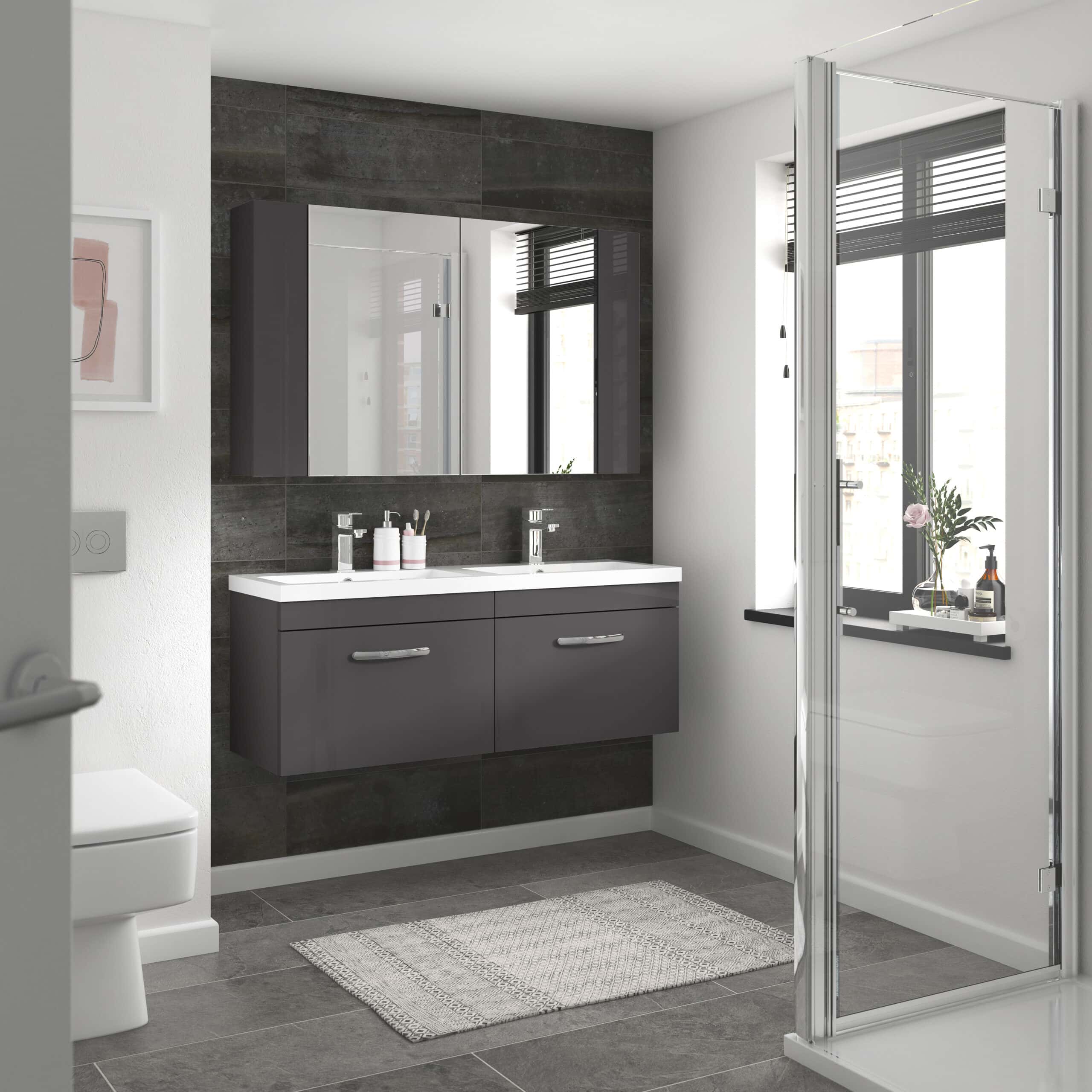 Contemporary double vanity bathroom with dark grey cabinetry, large mirror, and natural light from a window, showcasing modern bathroom design and storage solutions.