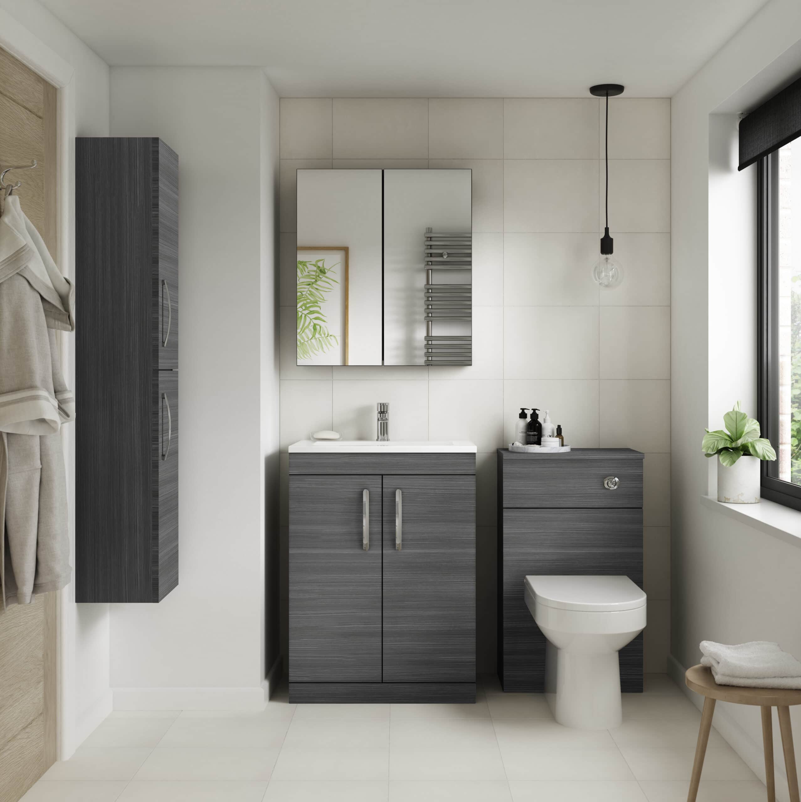 Modern grey bathroom vanity with white sink and wall-mounted mirror, adjacent to a toilet and black towel radiator in a contemporary bathroom with natural light from a large window.