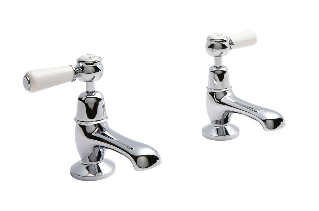 Polished chrome bathroom taps with white ceramic handles, perfect for traditional or vintage-style bathroom designs. High-quality fixtures from Bubly Bathrooms.