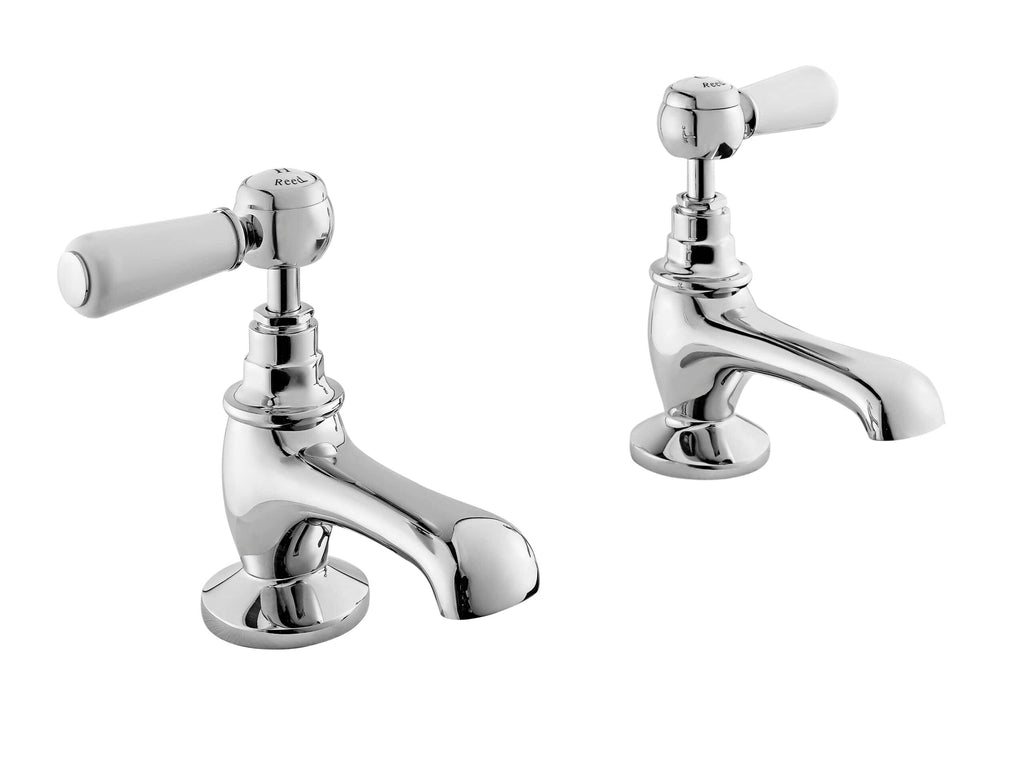 Chrome antique-style bathroom taps with white ceramic handles for vintage bathroom decor.