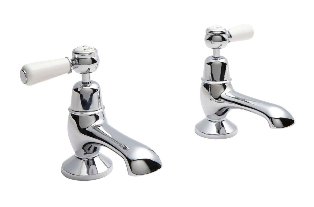 Chrome bathroom basin taps with white ceramic handles, ideal for bathroom renovation and plumbing upgrades. Modern design suitable for contemporary bathroom installations.
