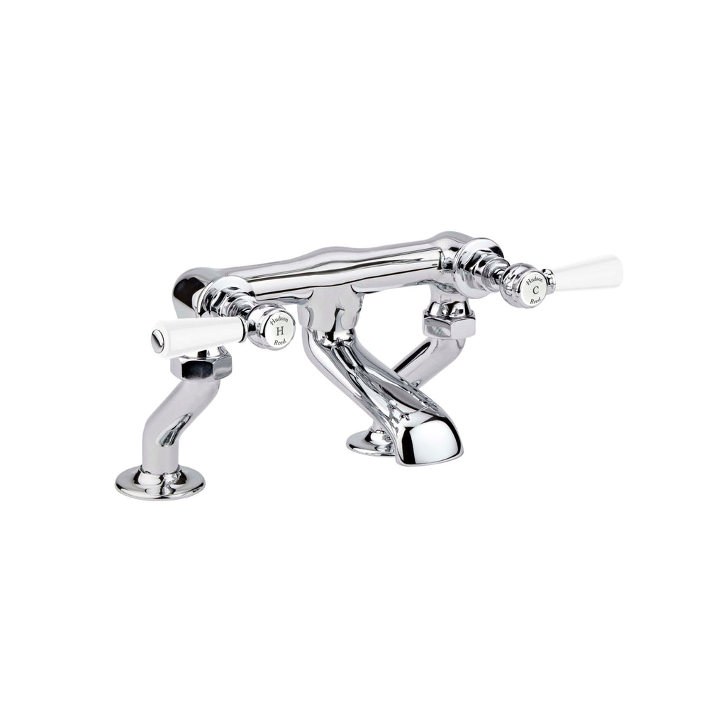 Shiny chrome bathroom sink tap with white handles, traditional design, includes dual control valves, ideal for classic or vintage style bathrooms. Perfect for modern bathroom fixtures.
