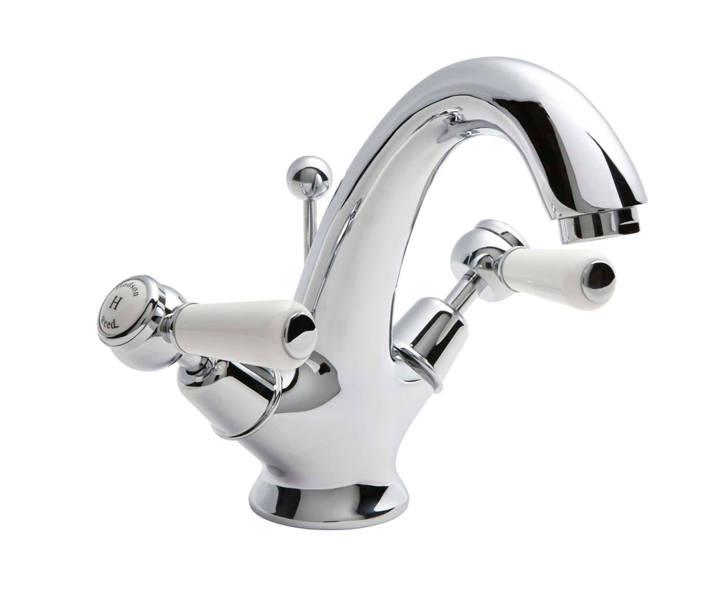 Chrome bathroom mixer tap with white ceramic handles and sleek design, ideal for modern bathrooms, combining style and functionality for optimal water control.