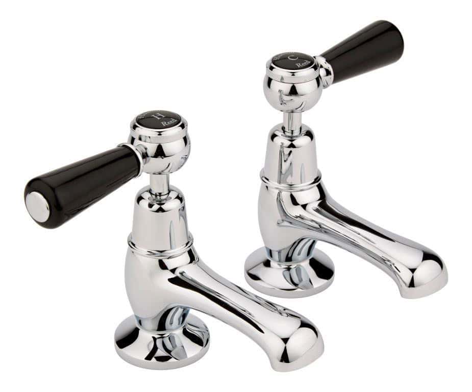 Polished chrome bathroom taps with black handle knobs, ideal for modern bathroom sink fixtures.