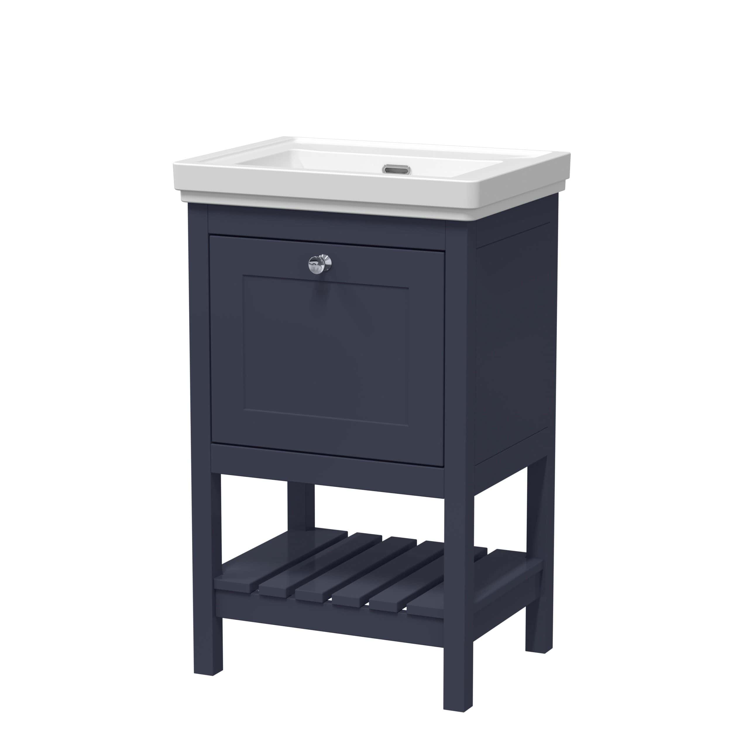 White ceramic bathroom sink with navy blue wooden cabinet and storage shelf, ideal for modern bathroom decor. Featuring a sleek, stylish design with ample space underneath for bathroom accessories.