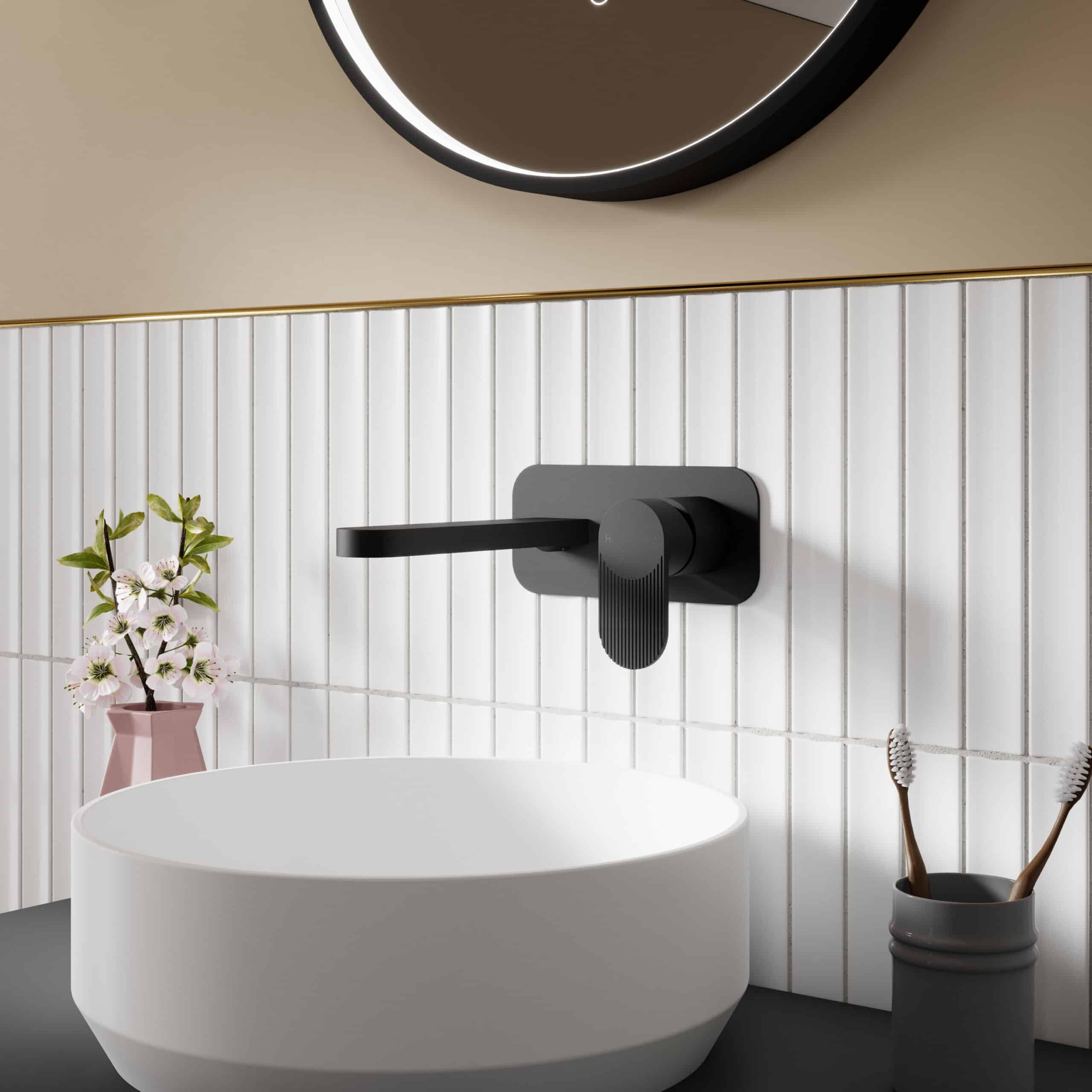 Sleek black bathroom tap with matte finish on white tiled wall, modern bathroom decor with round mirror, vase with flowers, and toothbrush holder, emphasizing contemporary stylish bathroom fixtures.