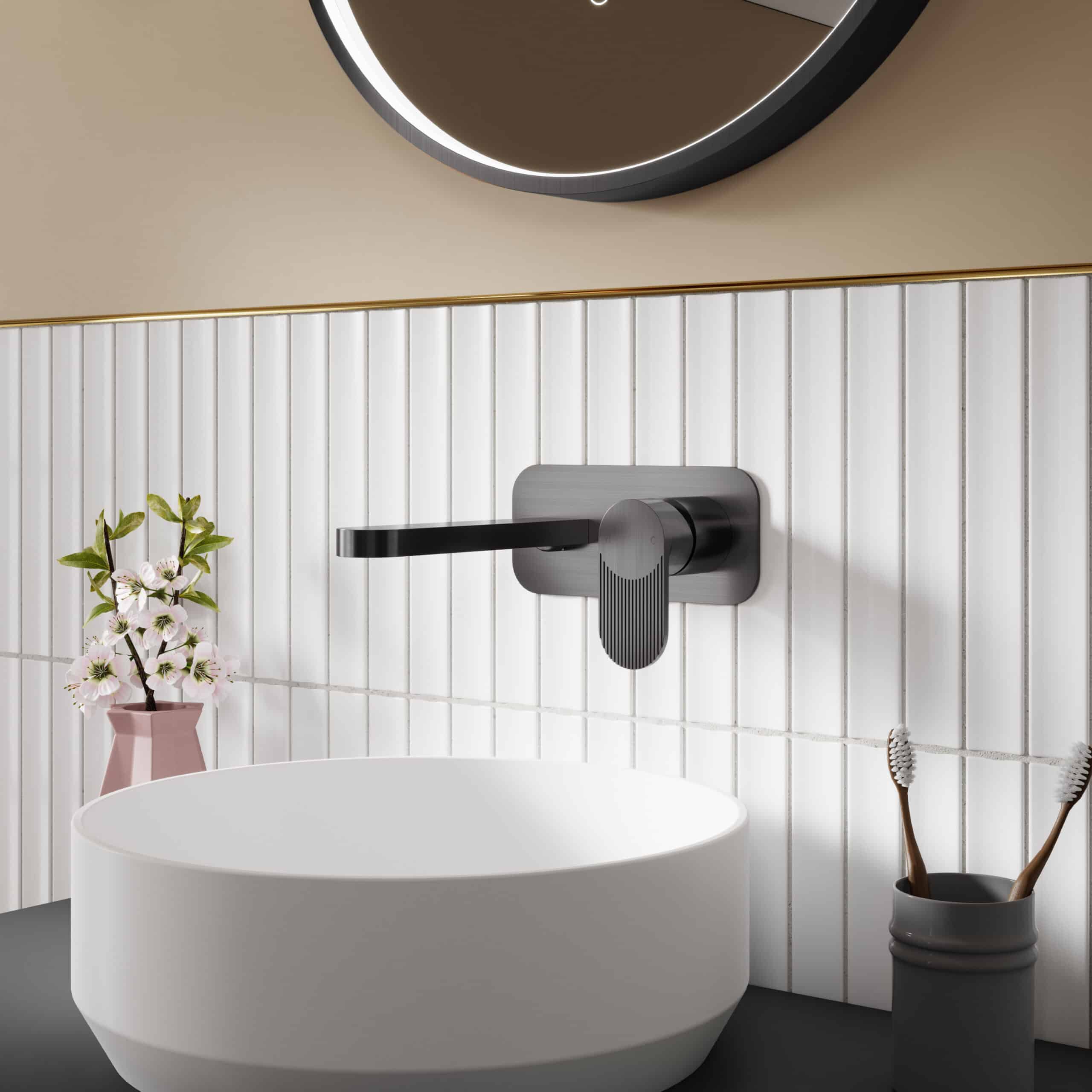Sleek black matte bathroom sink faucet with modern handle, set against white tiled wall, complemented by a round mirror, pink flower vase, and toothbrush holder for stylish bathroom decor.
