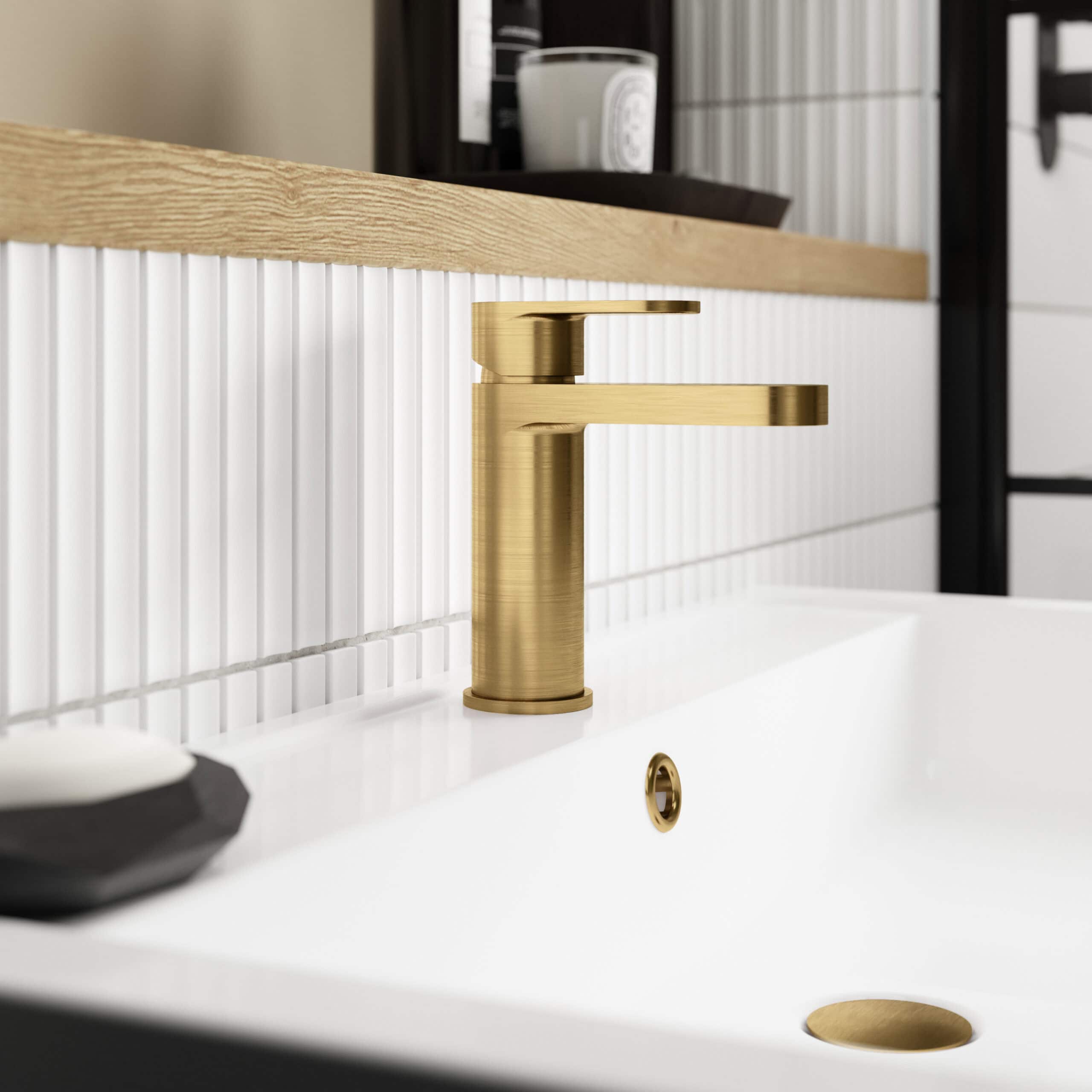 Brass bathroom faucet with modern design on white ceramic sink, stylish and durable kitchen and bathroom fixture.