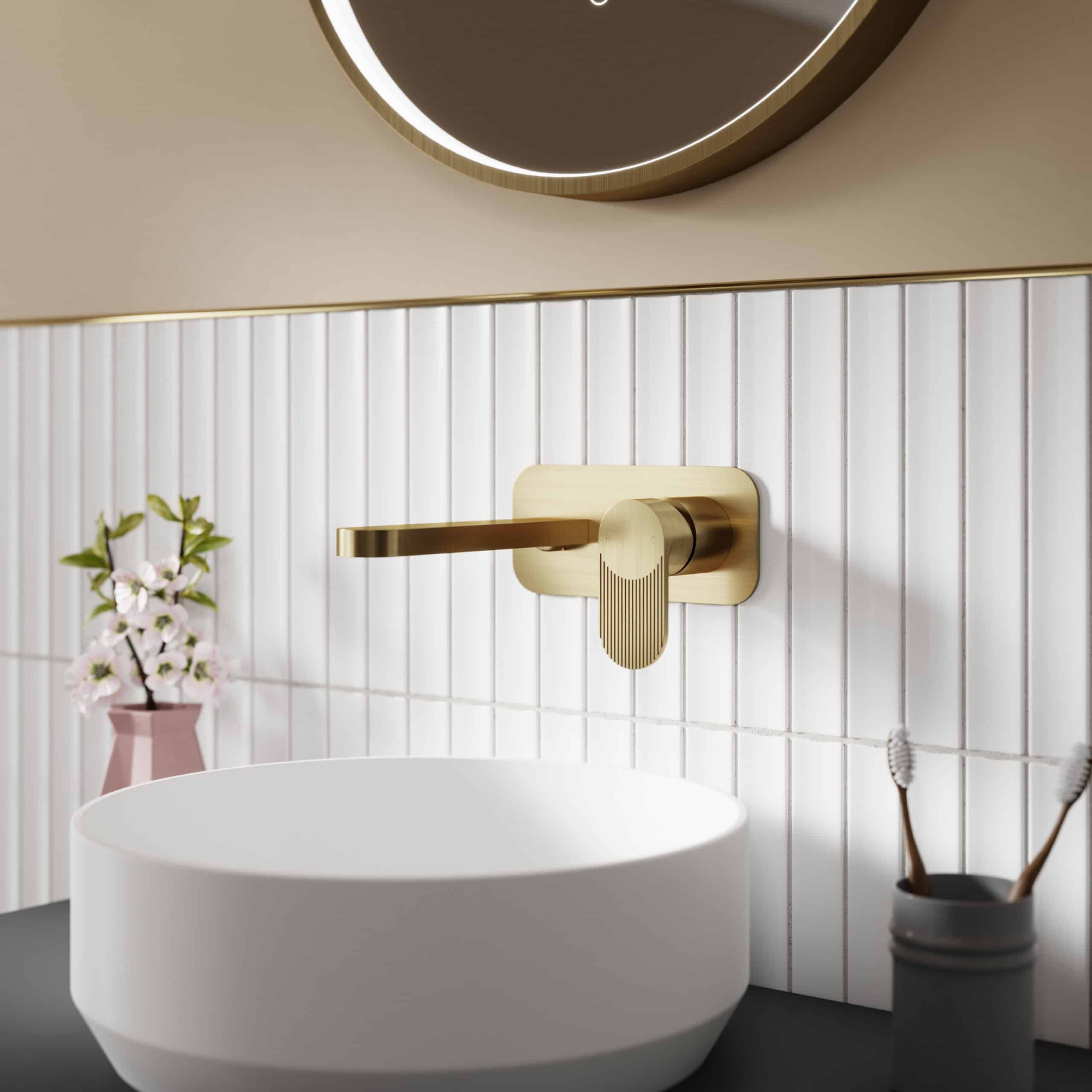 Elegant gold bathroom tap with modern design, set above a white ceramic sink on a black countertop, with a mirror, dental brushes in a holder, and a pink vase with flowers, creating a luxurious bathroom aesthetic.
