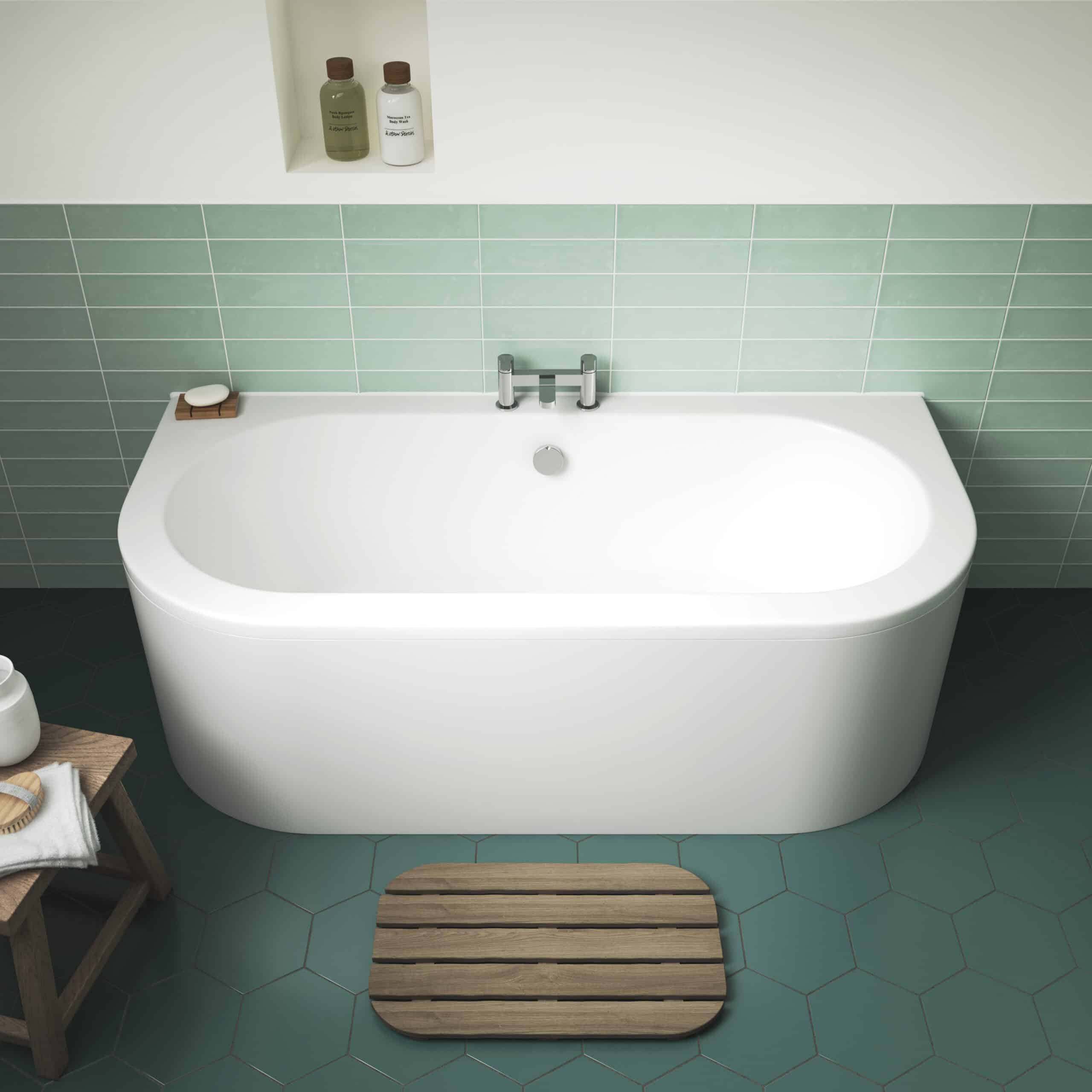 Relaxing modern freestanding bathtub with minimalist design, white finish, and sleek chrome fixtures in contemporary bathroom setting with green tiles.