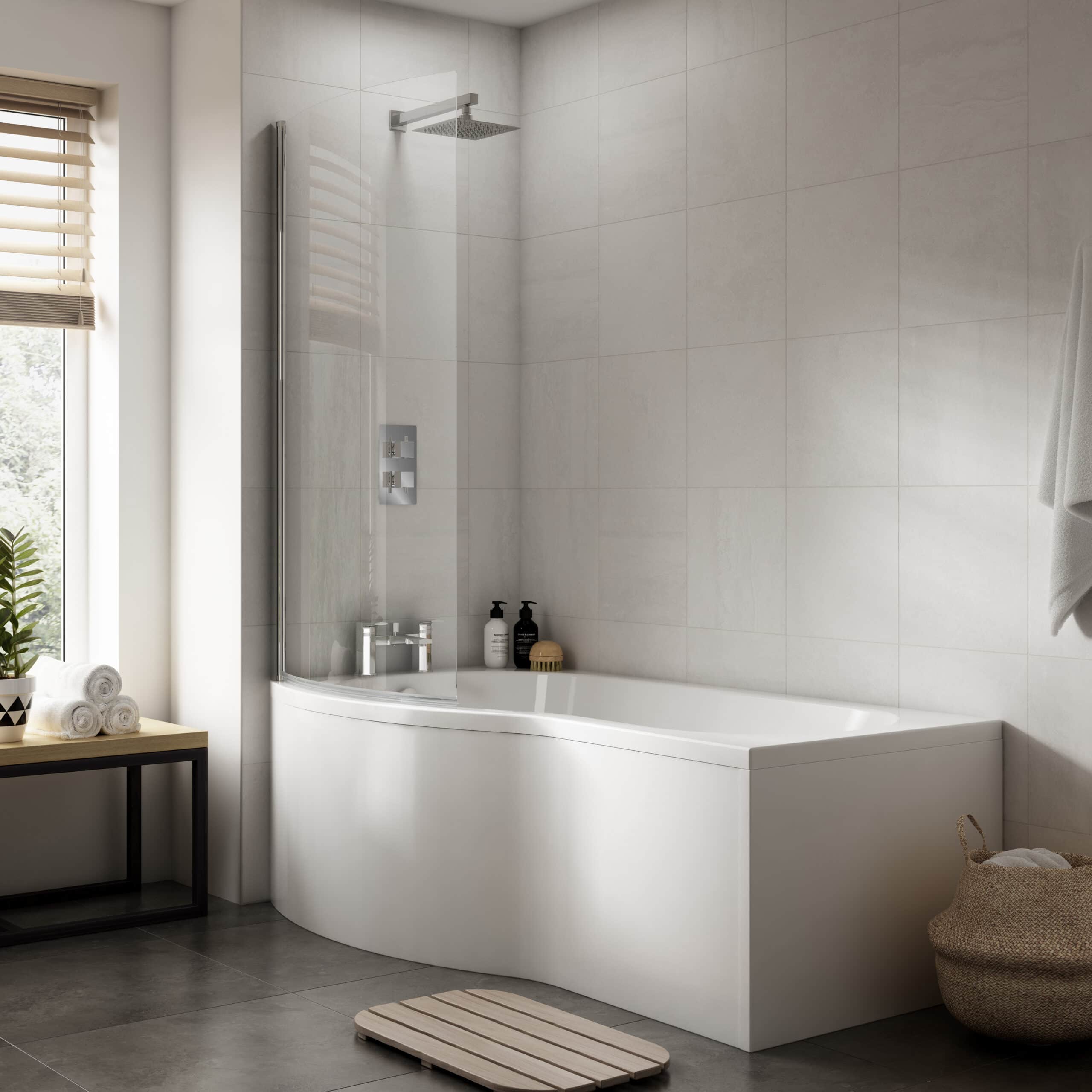 Modern white bathtub with shower screen and minimalist bathroom decor, featuring neutral tones and natural light, designed by Bubly Bathrooms for elegant bathroom refurbishment.