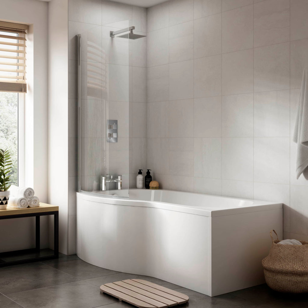Modern white bathtub with shower screen and minimalist bathroom decor, featuring neutral tones and natural light, designed by Bubly Bathrooms for elegant bathroom refurbishment.