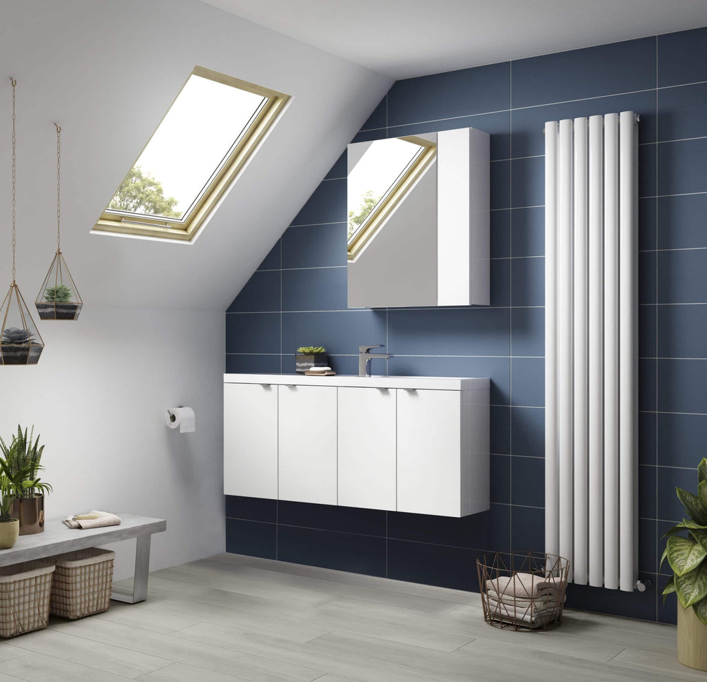 Modern bathroom with white vanity, blue wall tiles, radiator, skylights, and minimalist decor in a stylish attic conversion.