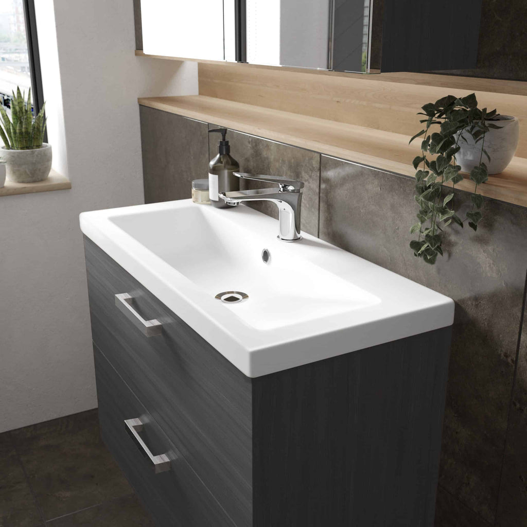 Contemporary bathroom vanity with integrated sink, dark wood finish, and modern chrome faucet. Minimalist design, ideal for stylish and functional bathroom upgrades.