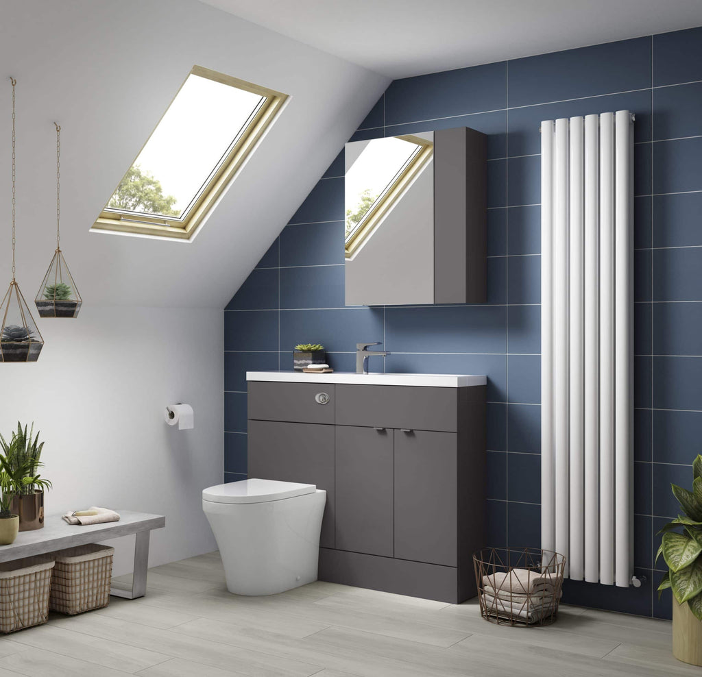 Modern bathroom with grey vanity unit, white toilet, stylish radiator, and skylight windows, featuring contemporary tile design and green plants for a fresh, minimalist look.