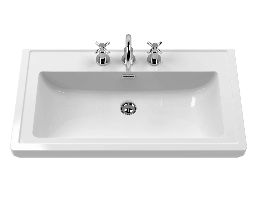Shiny white bathroom sink with chrome tap and handles, modern design, ideal for stylish bathroom renovations and vanity areas. Durable ceramic material for long-lasting use.
