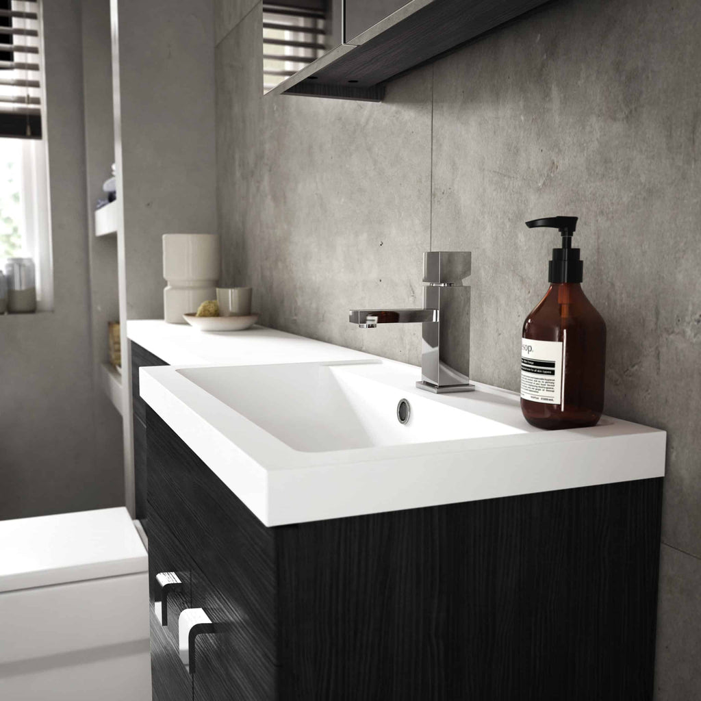 Sleek modern bathroom sink with a black vanity, chrome tap, and brown soap dispenser against grey textured wall, minimalistic design, ideal for contemporary bathroom interiors.