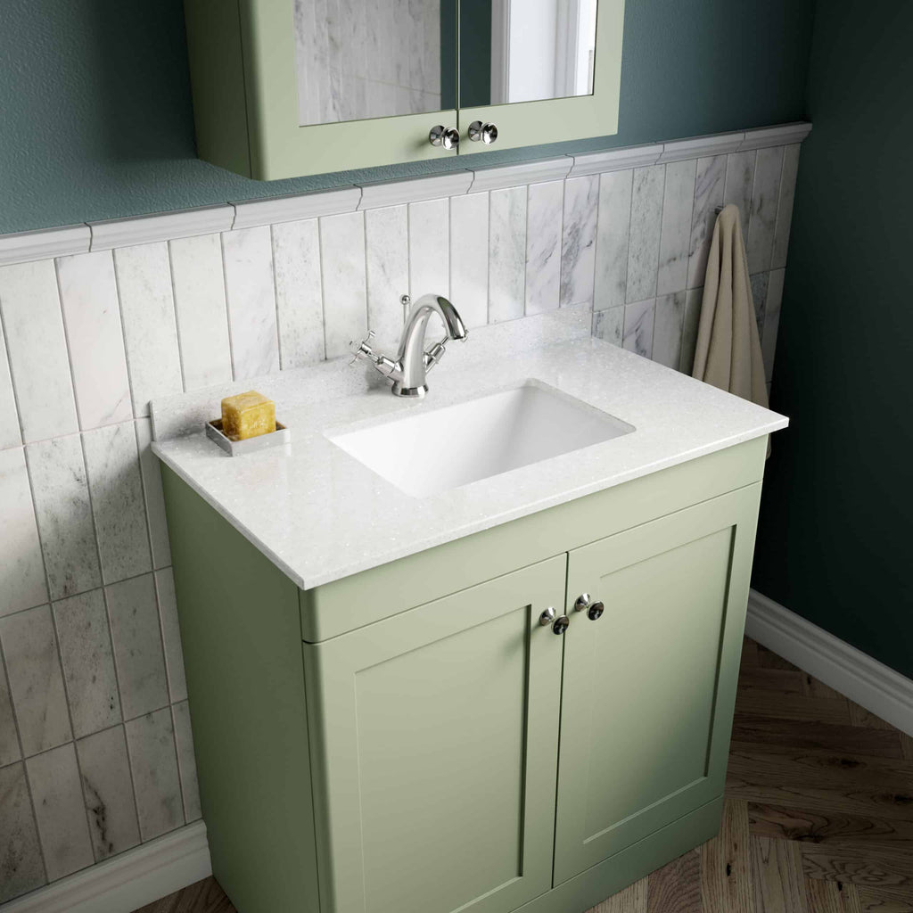 Bright green bathroom vanity with white countertop and rectangular sink, complemented by a chrome faucet and wall-mounted mirror cabinet, in a stylish and modern bathroom setting.