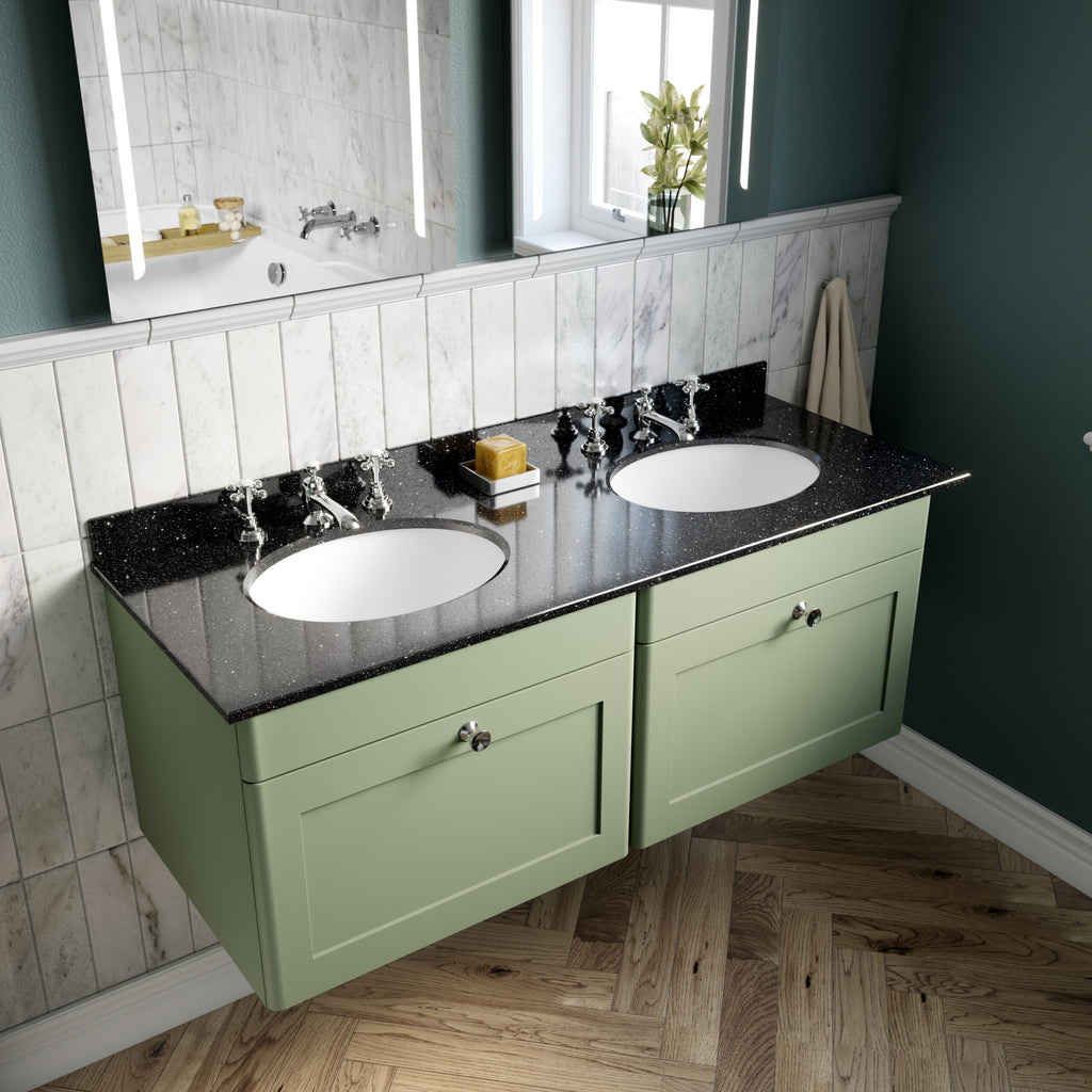 Bright green double bathroom vanity with a black speckled countertop, dual sinks, vintage-style chrome taps, and a large mirror, creating a stylish and functional space for modern bathrooms.