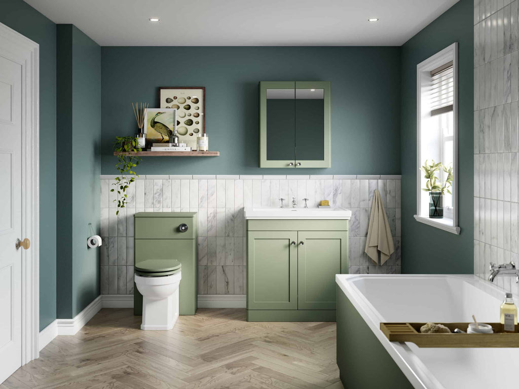 Modern green bathroom with a bathtub, toilet, and vanity unit, featuring stylish decor, marble tiles, and natural light, perfect for relaxing and contemporary bathroom design.
