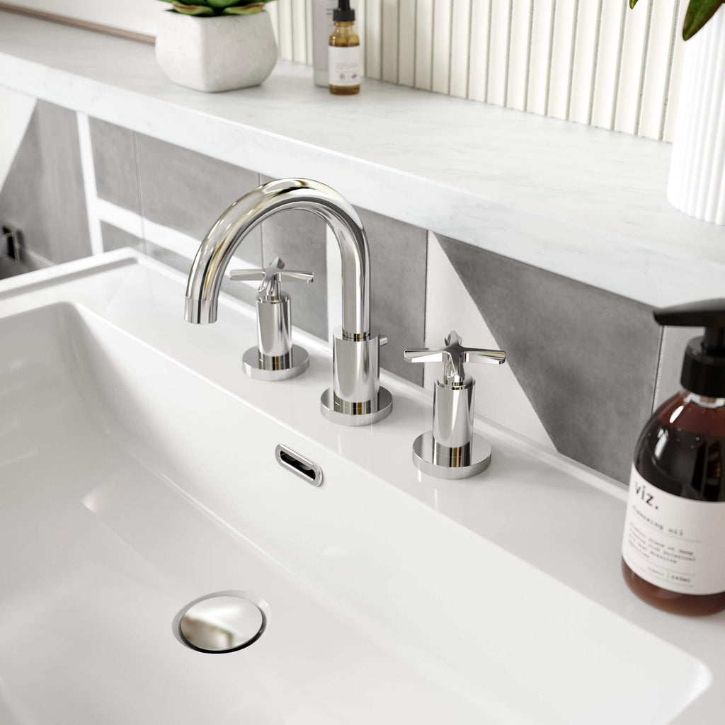 Polished chrome bathroom taps and sink with modern design, stylish grey tiled backsplash, and decorative bathroom accessories, showcasing contemporary bathroom fixtures from Bubly Bathrooms.