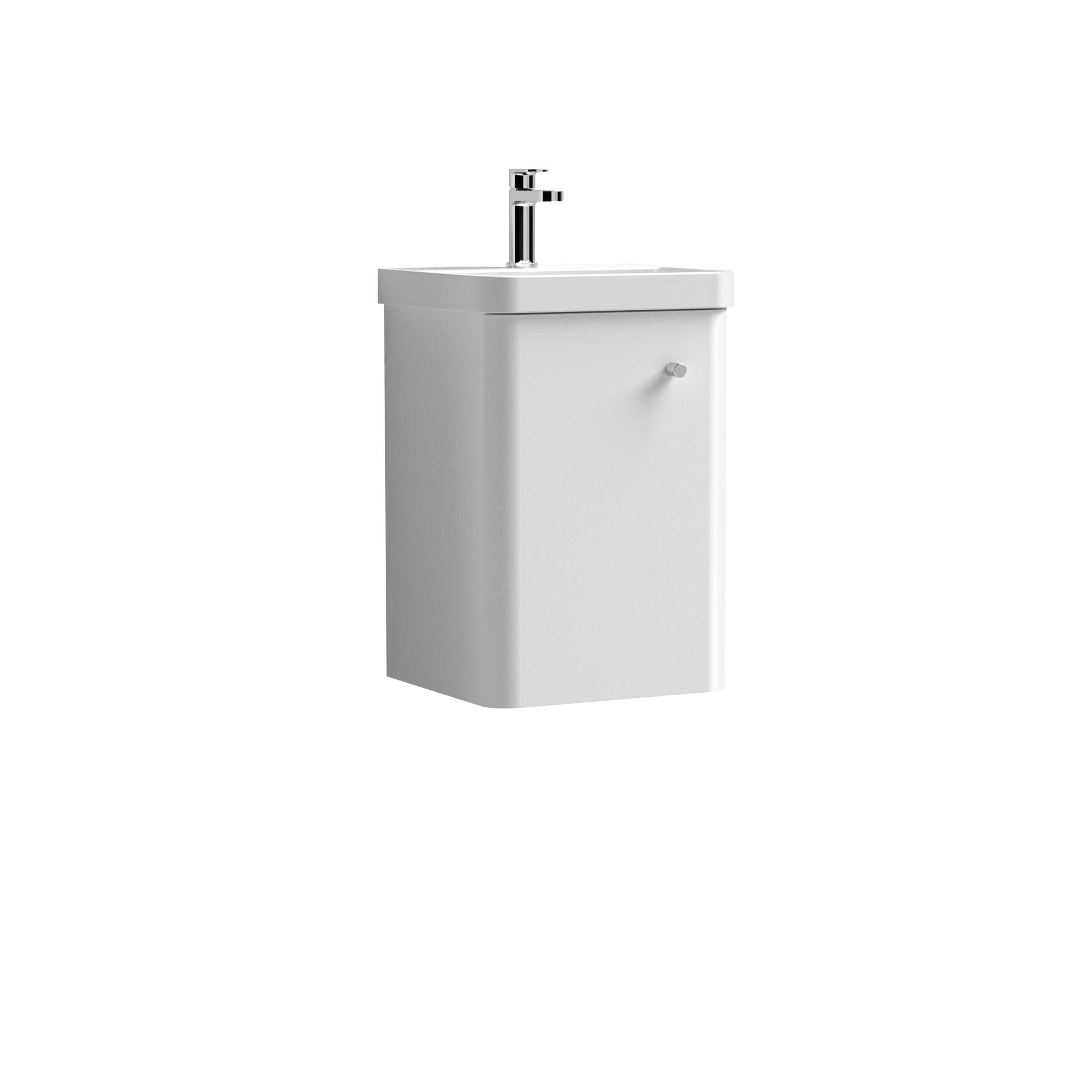Minimalist white bathroom sink unit with integrated tap on a plain white background.