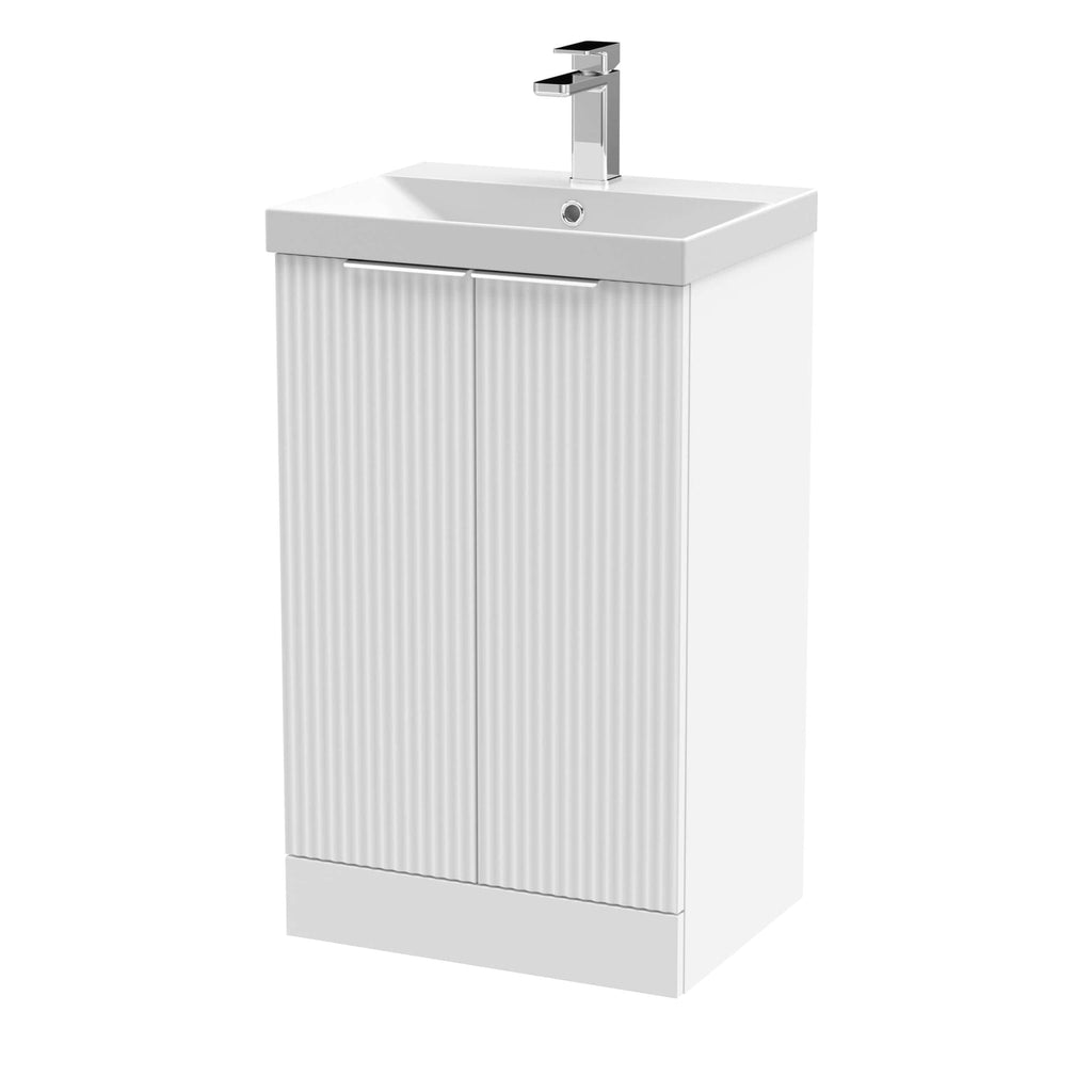 Modern white bathroom vanity with integrated sink and sleek chrome faucet, ideal for contemporary bathroom designs. Durable cabinetry with vertical ribbed doors for storage.
