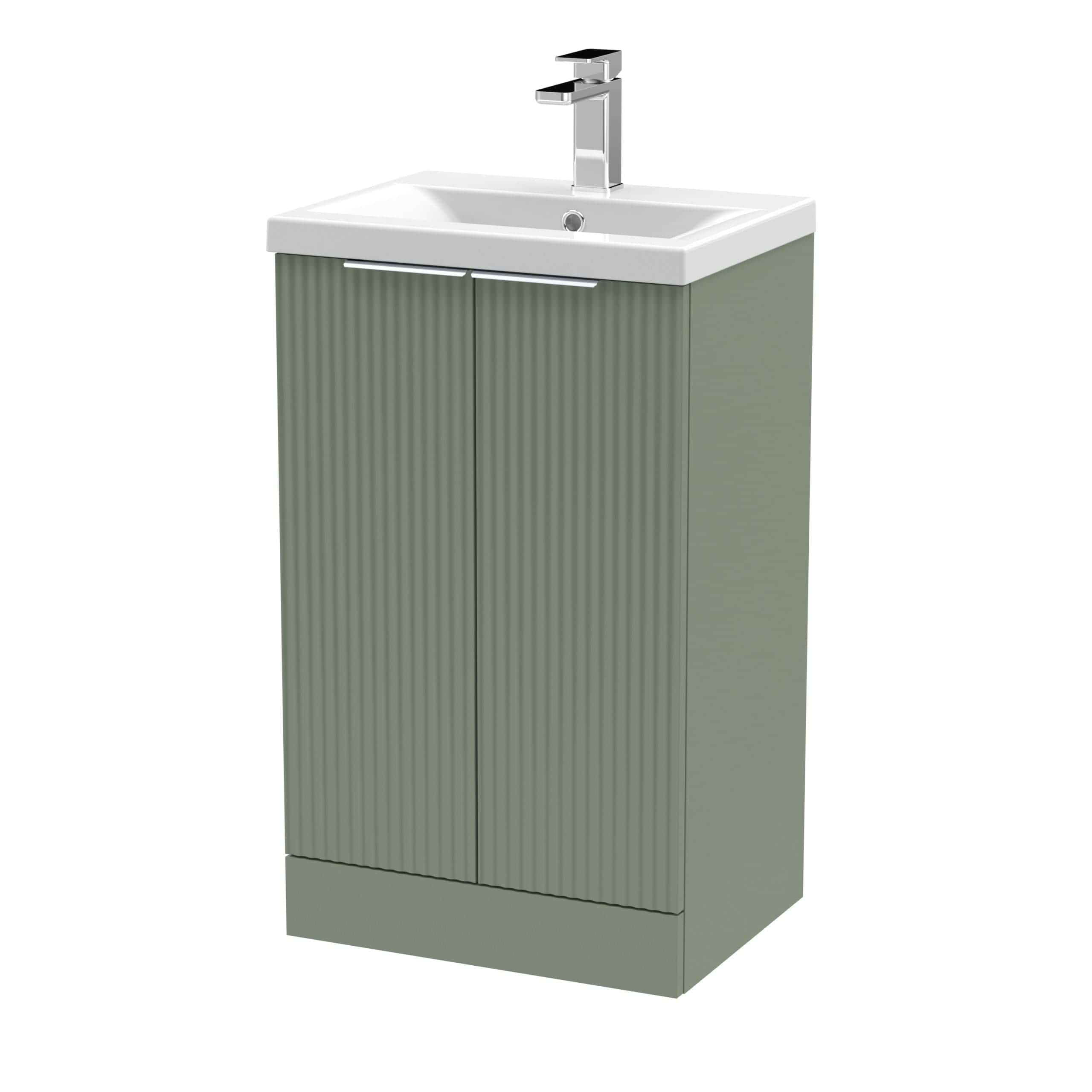 Sleek green bathroom vanity with a built-in white sink and modern chrome tap, ideal for contemporary bathroom interiors.