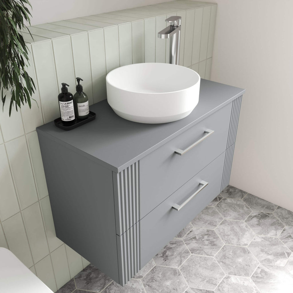 White modern bathroom vanity with vessel sink and chrome tap in light grey, minimalist bathroom decor.