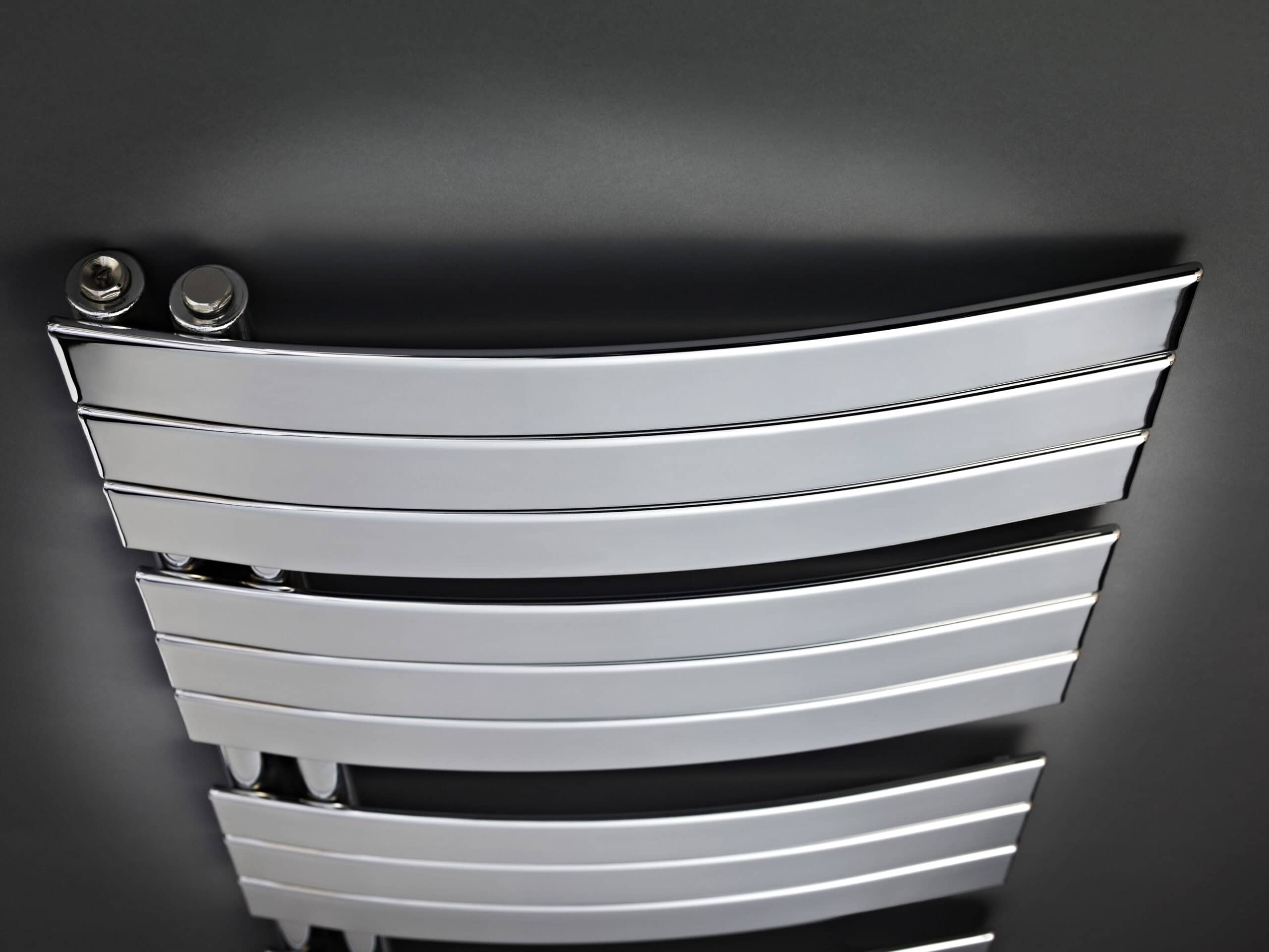 Polished chrome towel radiator in modern bathroom, perfect for warming towels and adding sleek style to bathroom decor.