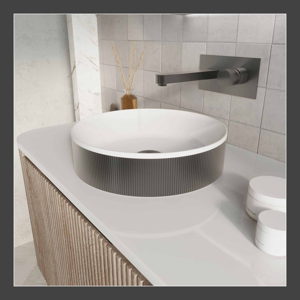 Sleek modern bathroom sink with a round vessel basin, wall-mounted matte black faucet, and minimalist decor, ideal for contemporary bathroom designs.