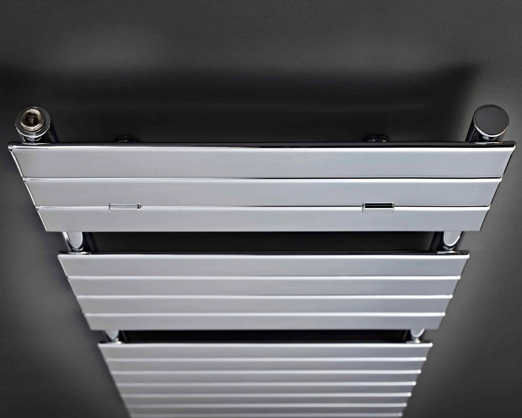 आधुनिक chrome and white heated towel radiator in a contemporary bathroom setting.